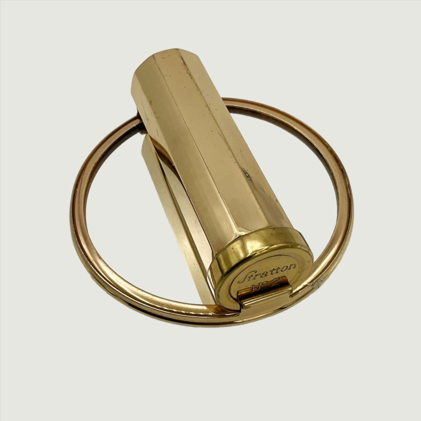 lipstick case with Stratton at the end and showing a clear reflective mirror