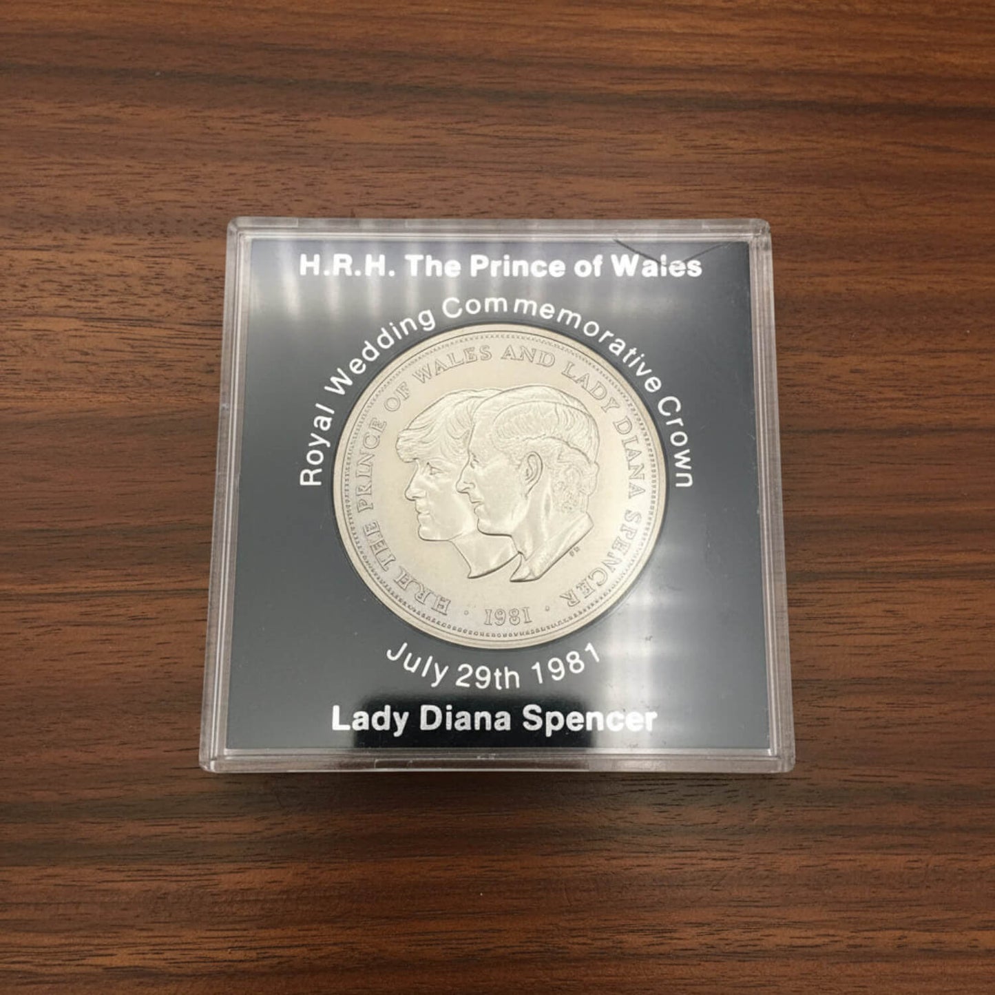 coin in a case on a wood surface