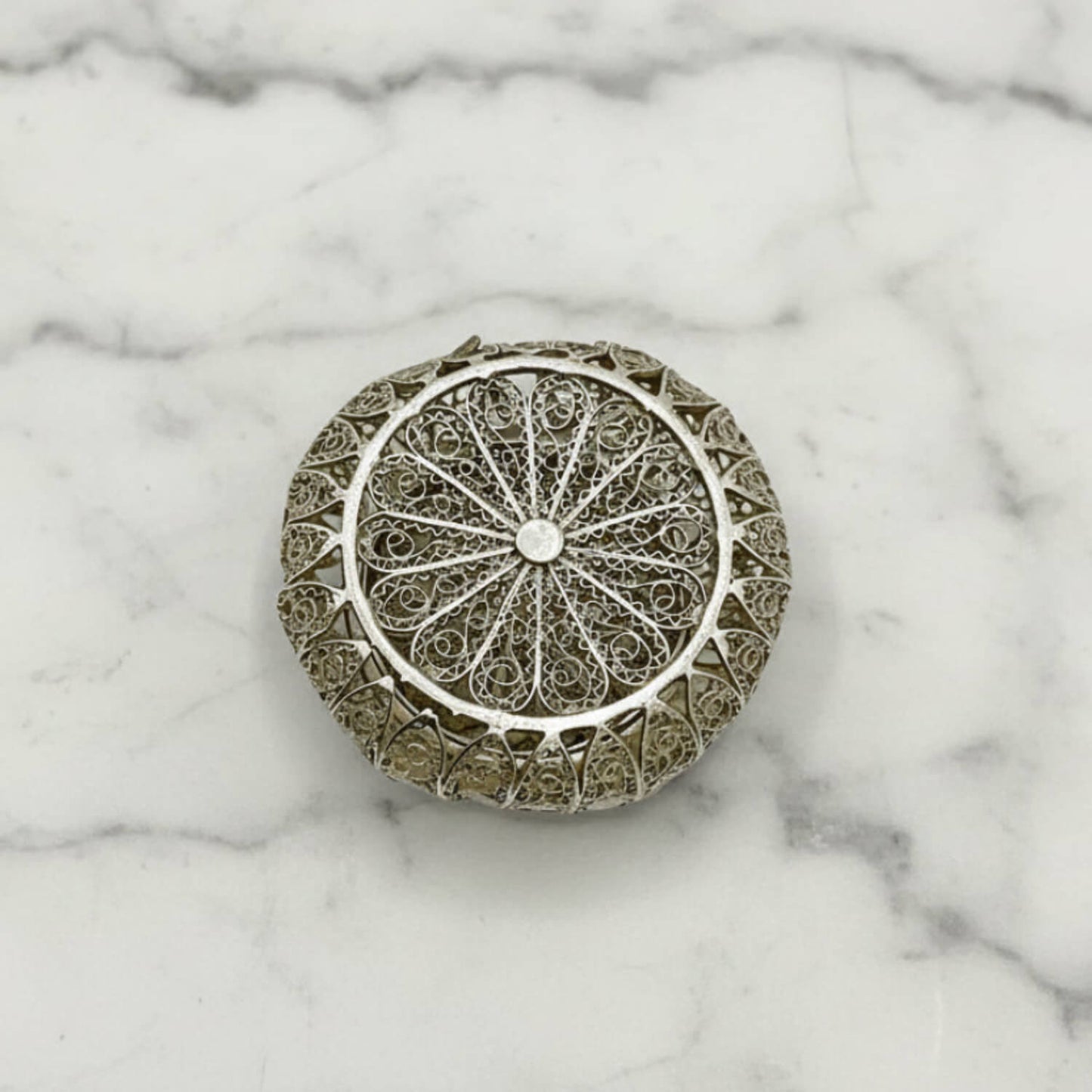 Antique Silver Filigree Box base on a marble surface