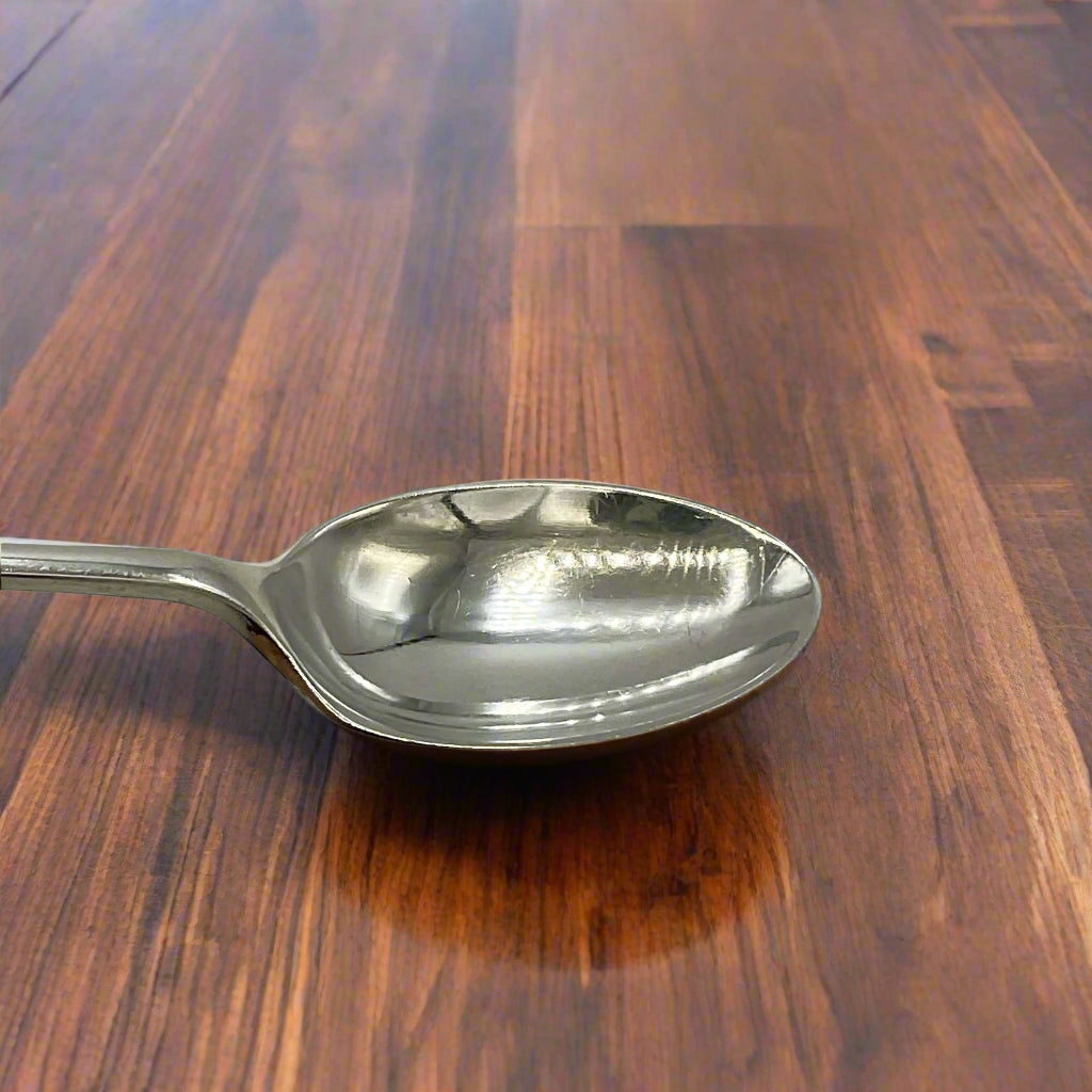 Silver spoon on a wood table