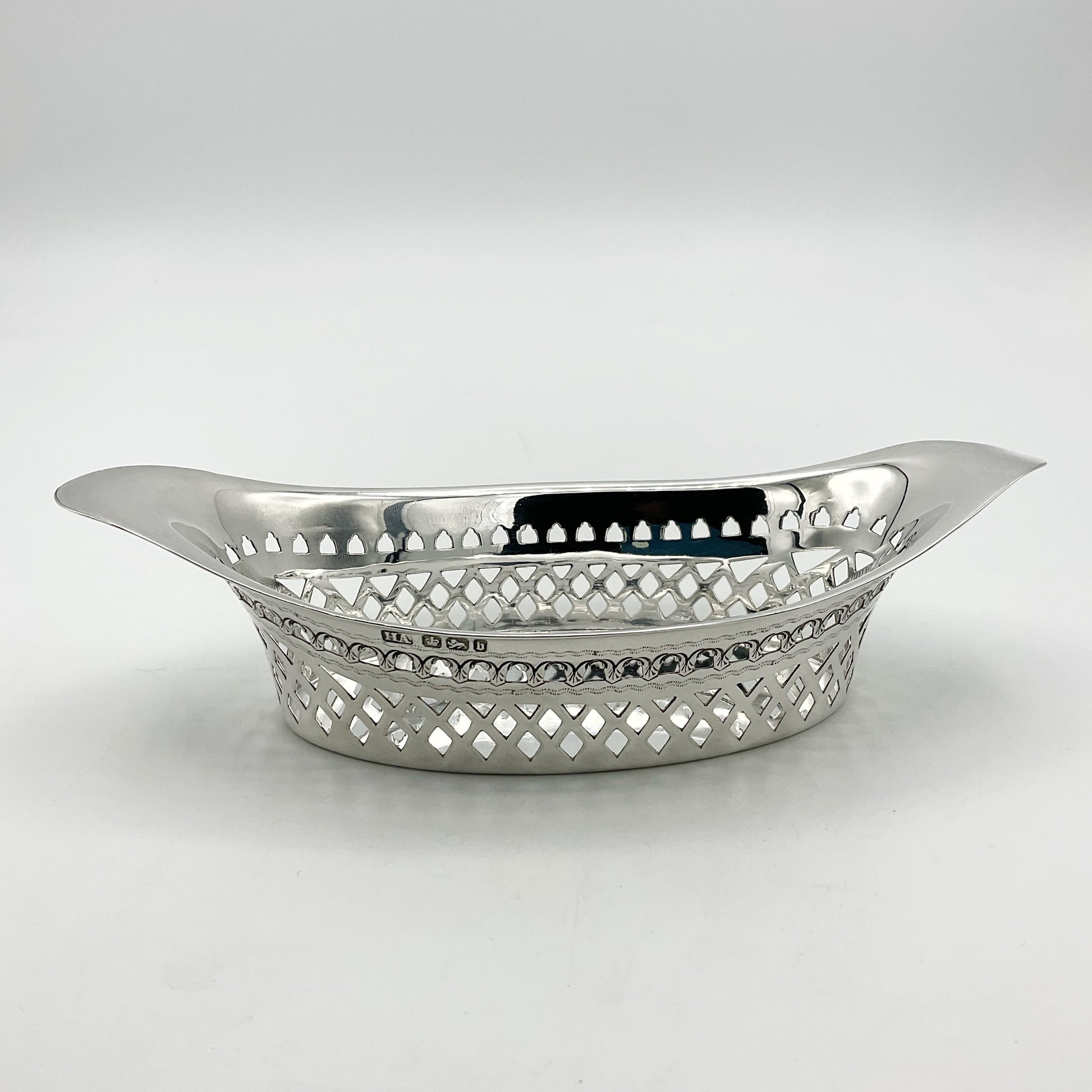 Antique Silver pierced bowl with hallmarks on white background