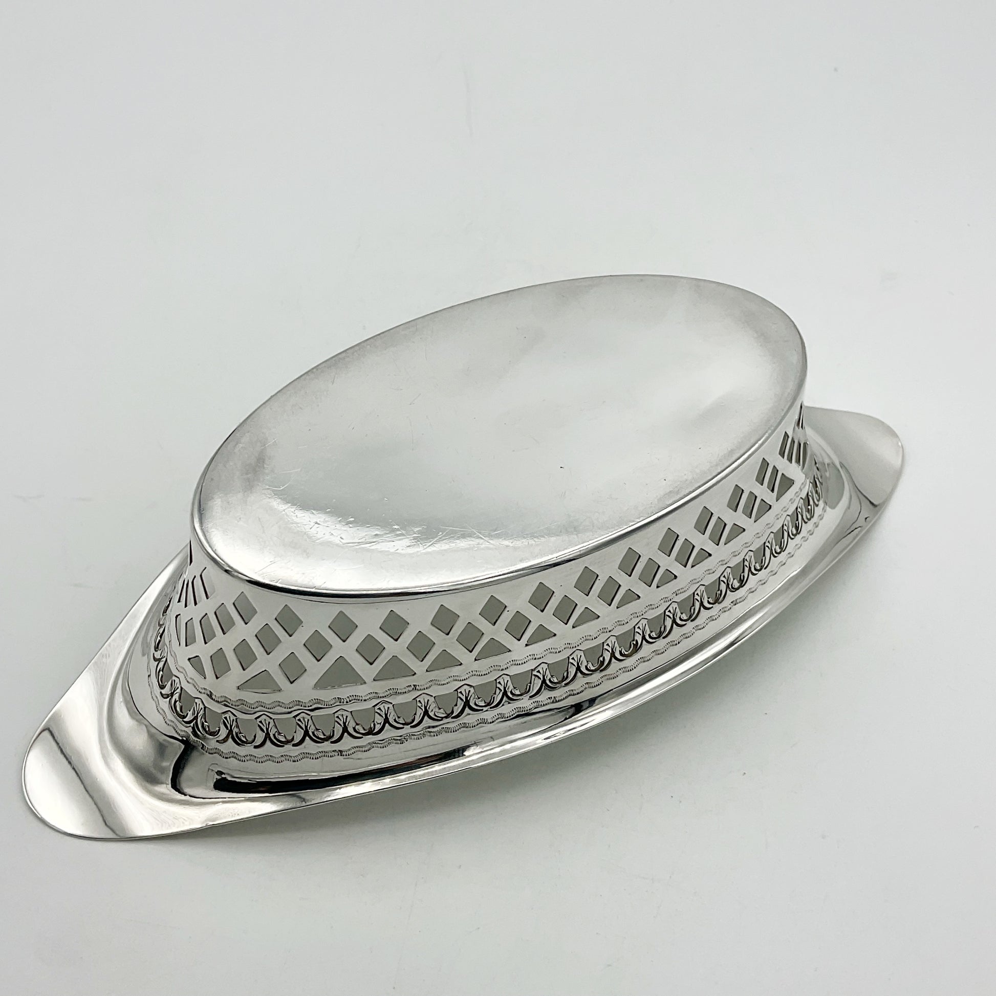Base of antique Silver pierced bowl upside down on white background 