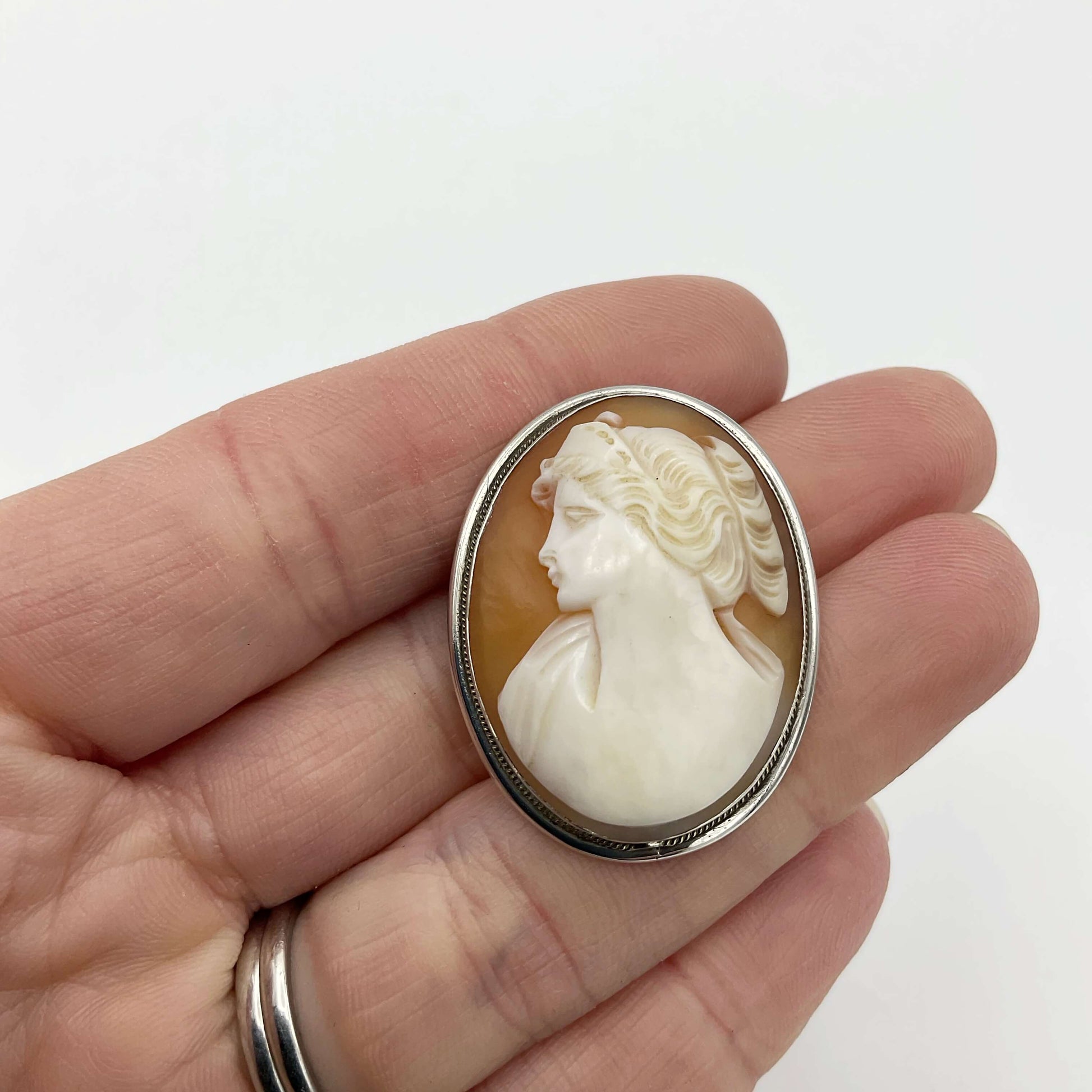 Cameo Silver Brooch held in a hand