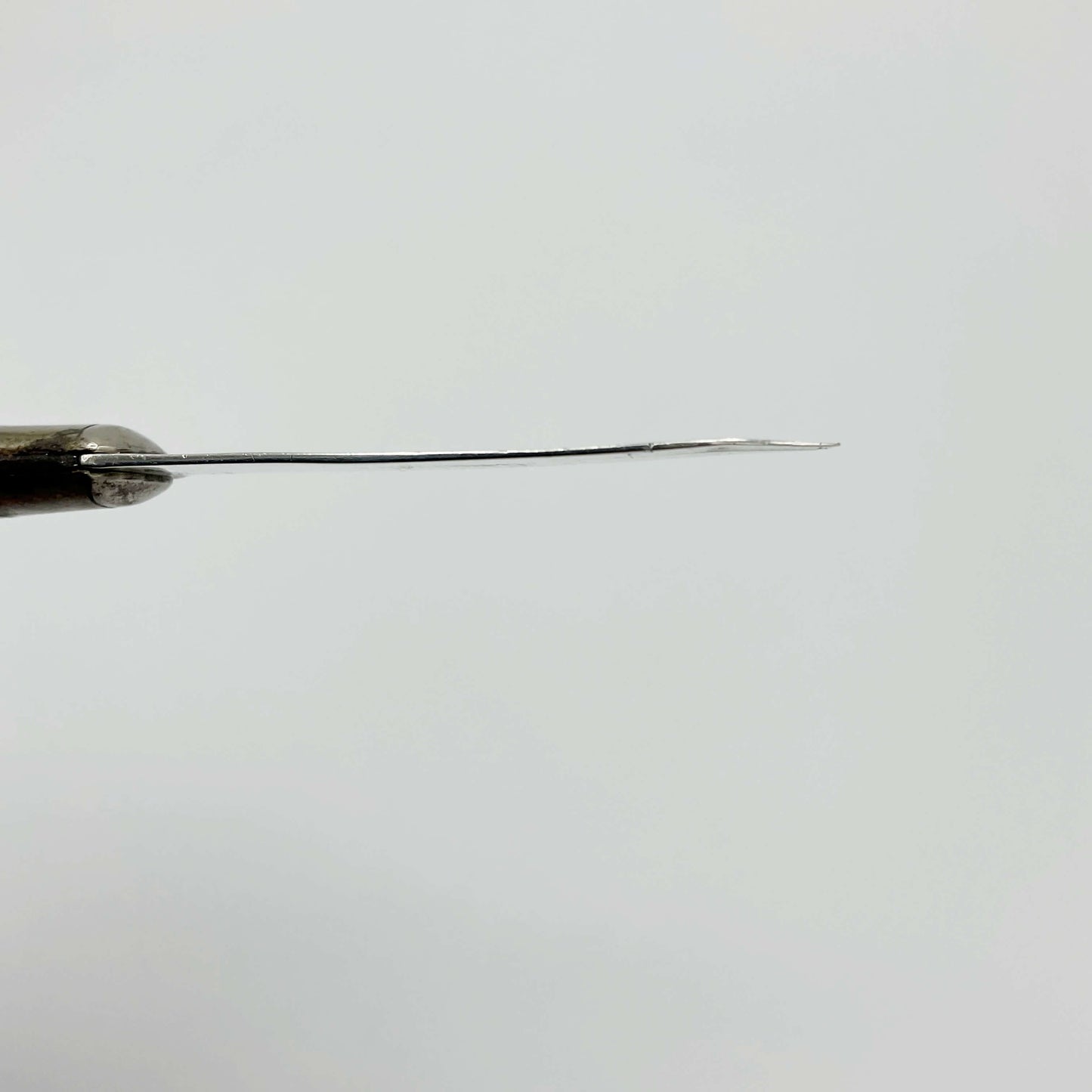 Side view of Sterling silver blade on a white background