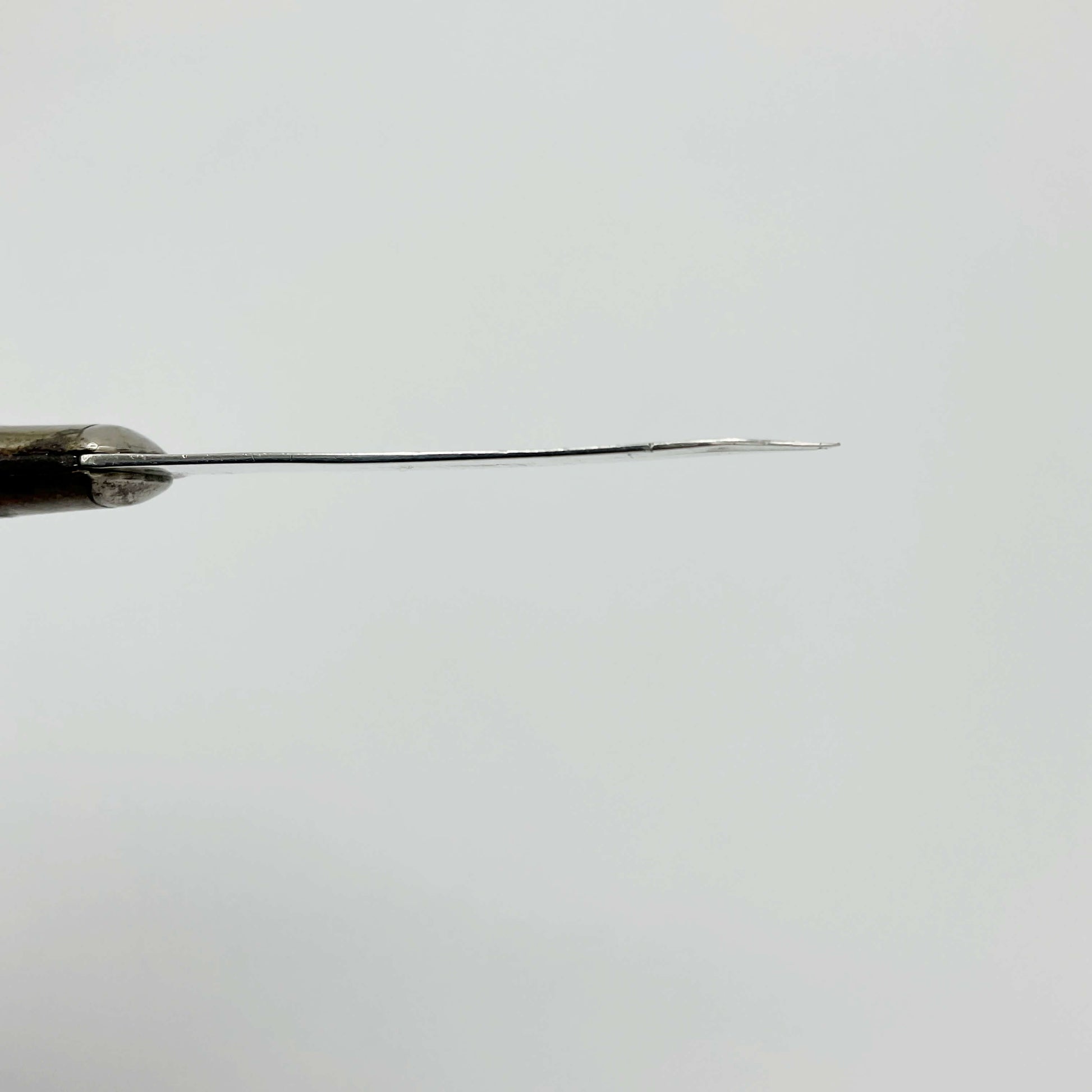 Side view of Sterling silver blade on a white background