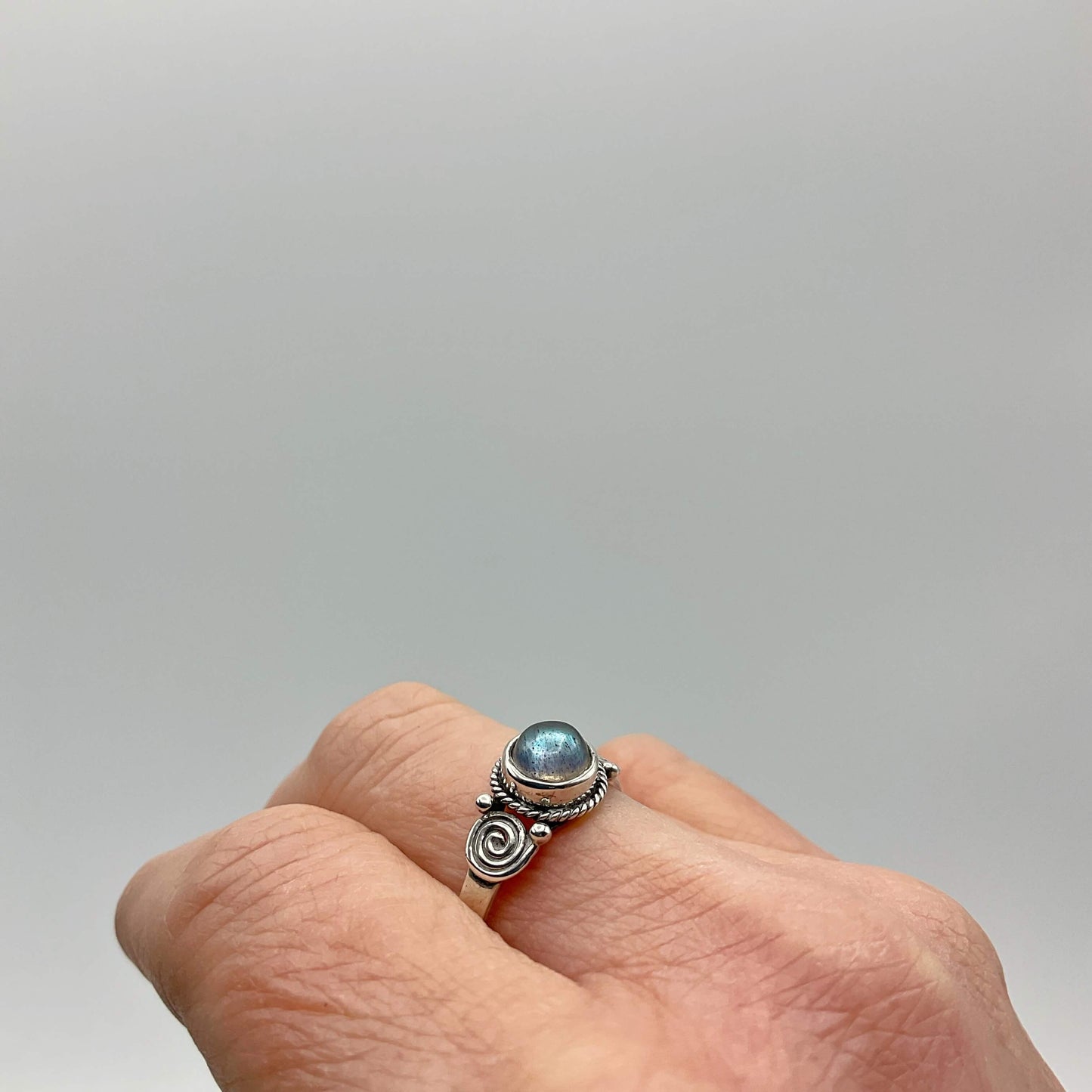 A beautiful blue moonstone silver ring on a finger
