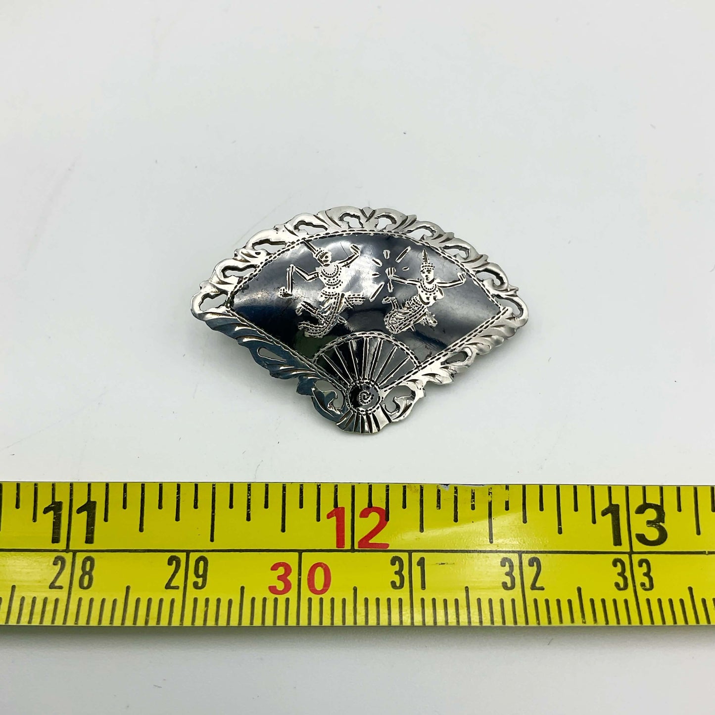Beautiful Silver Niello Brooch next to a tape measure.