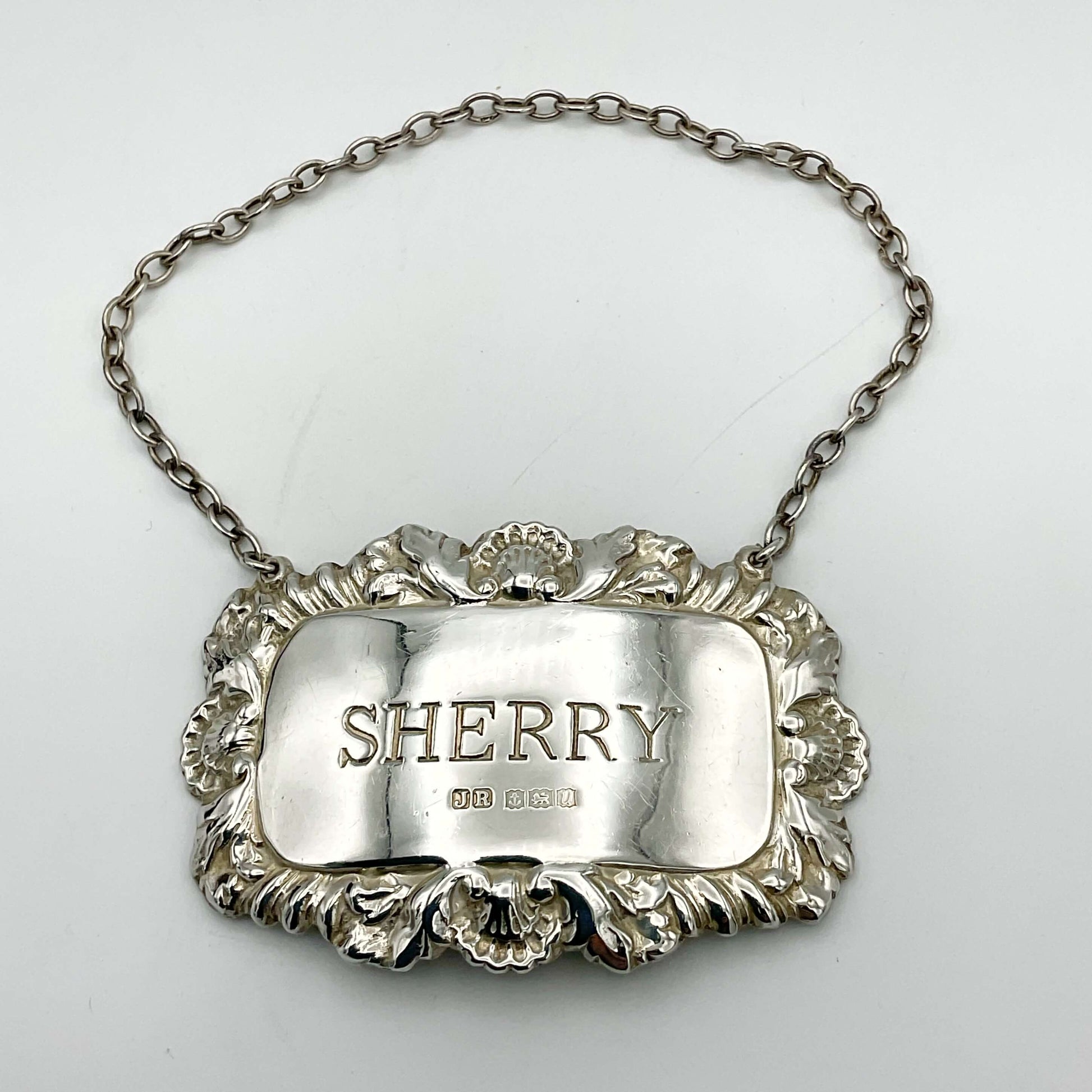 A shiny Sherry decanter label on a white background.