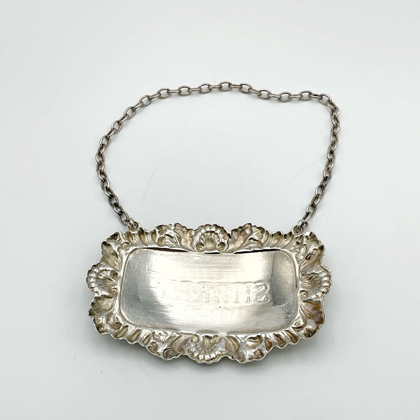 Back of A shiny Sherry decanter label on a white background.