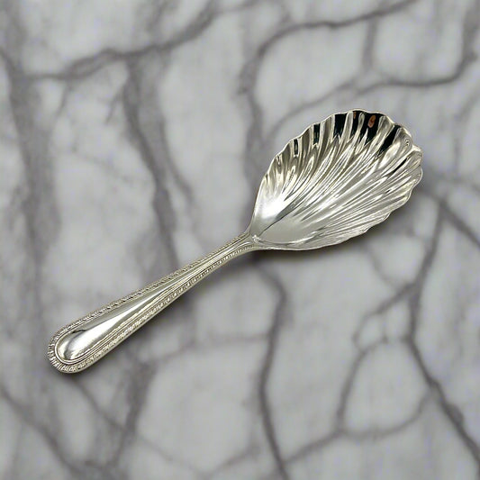 Sterling Silver Scallop Shaped Tea Caddy Spoon on a marble worktop