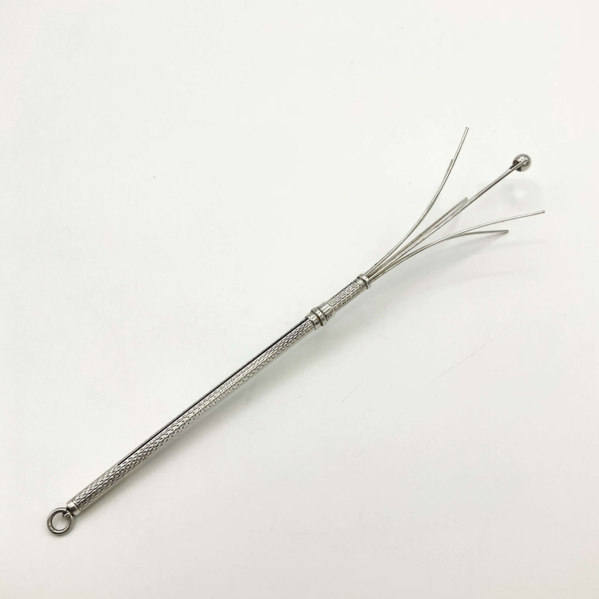 Silver whisk on a white background