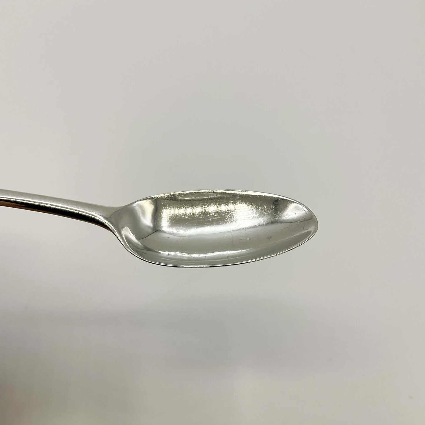 Bowl of Antique silver coffee spoon on a white background
