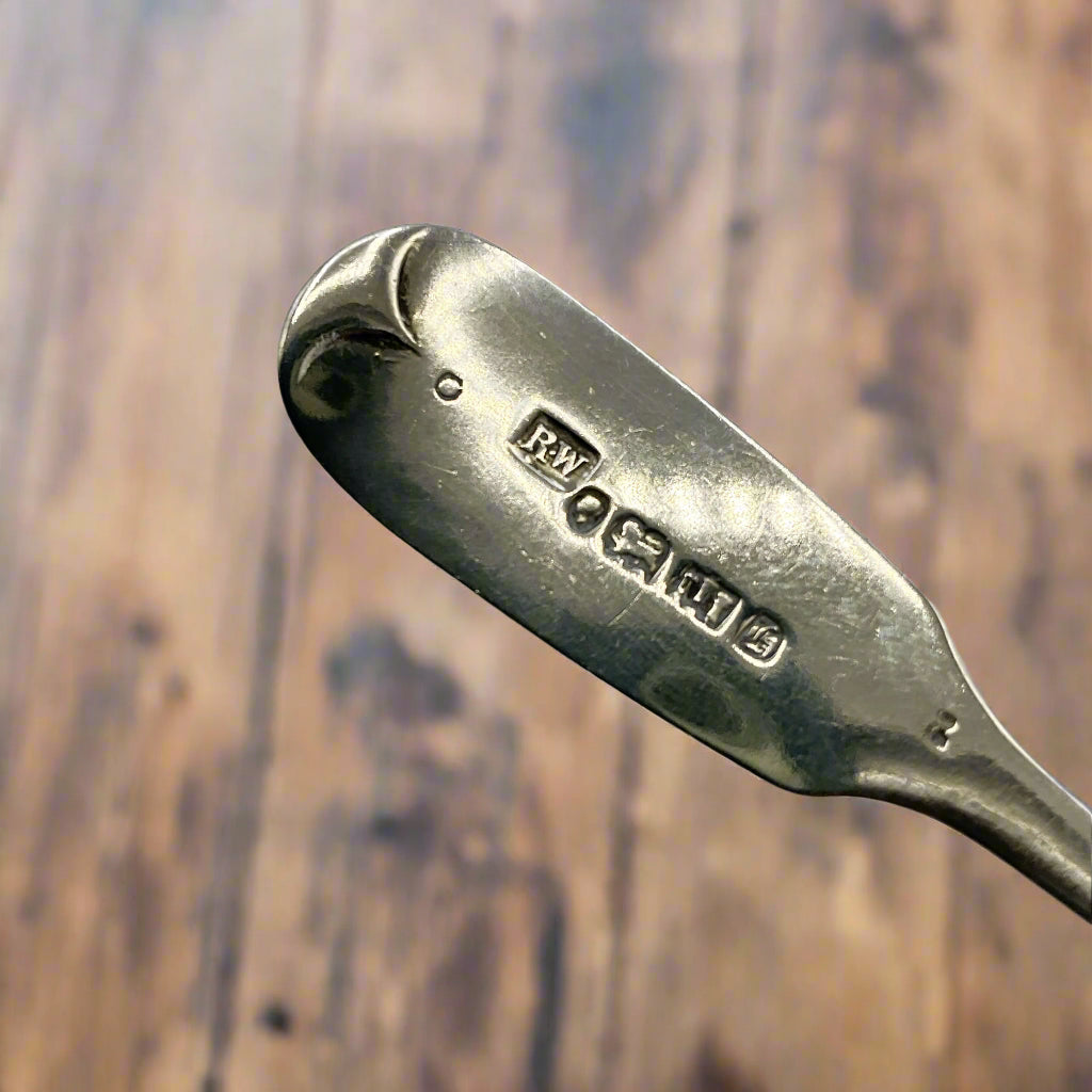 Hallmarks and maker’s mark on the back of a silver spoon handle
