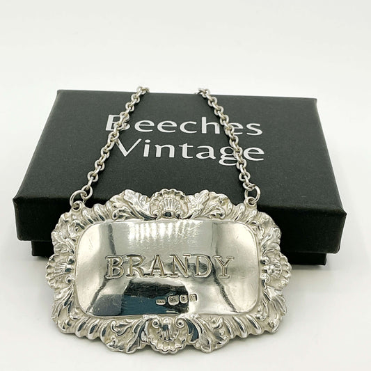 Silver 'BRANDY' decanter label with ornate design on a white background, featuring 'Beeches Vintage' packaging.