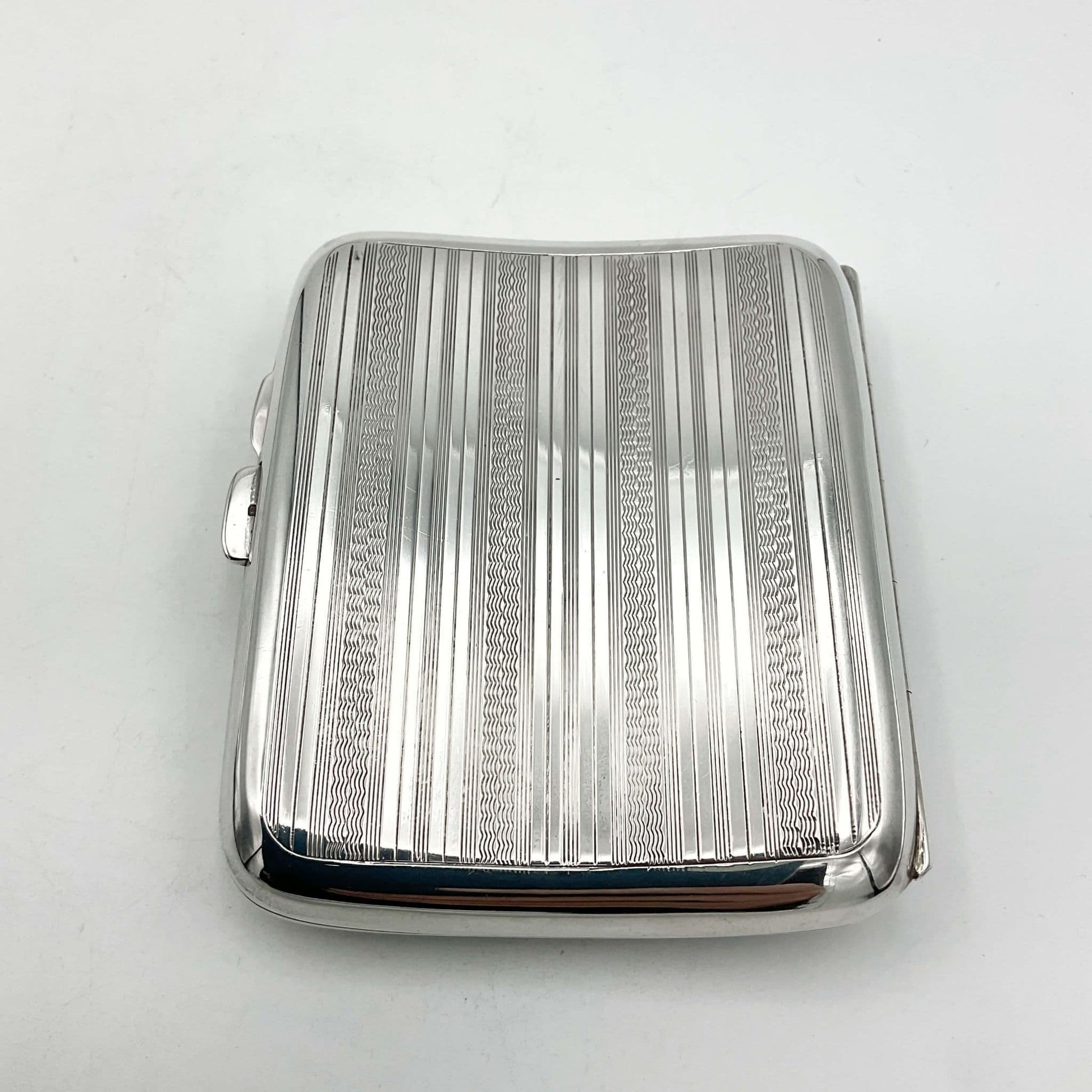 back of Antique 1920s silver cigarette case on a white background