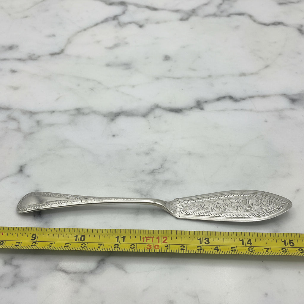 butter knife next to a tape measure for scale on a marble worktop