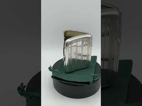 Video short of antique 1920s silver cigarette case on a green gift bag on a turntable