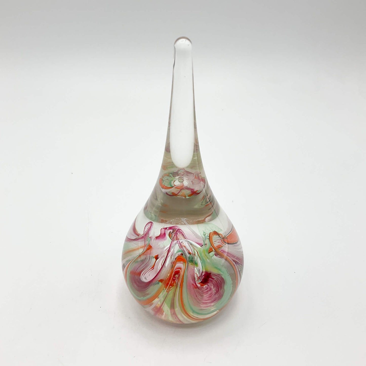 Selkirk glass paperweighrt with multicoloured swirls on a white background.