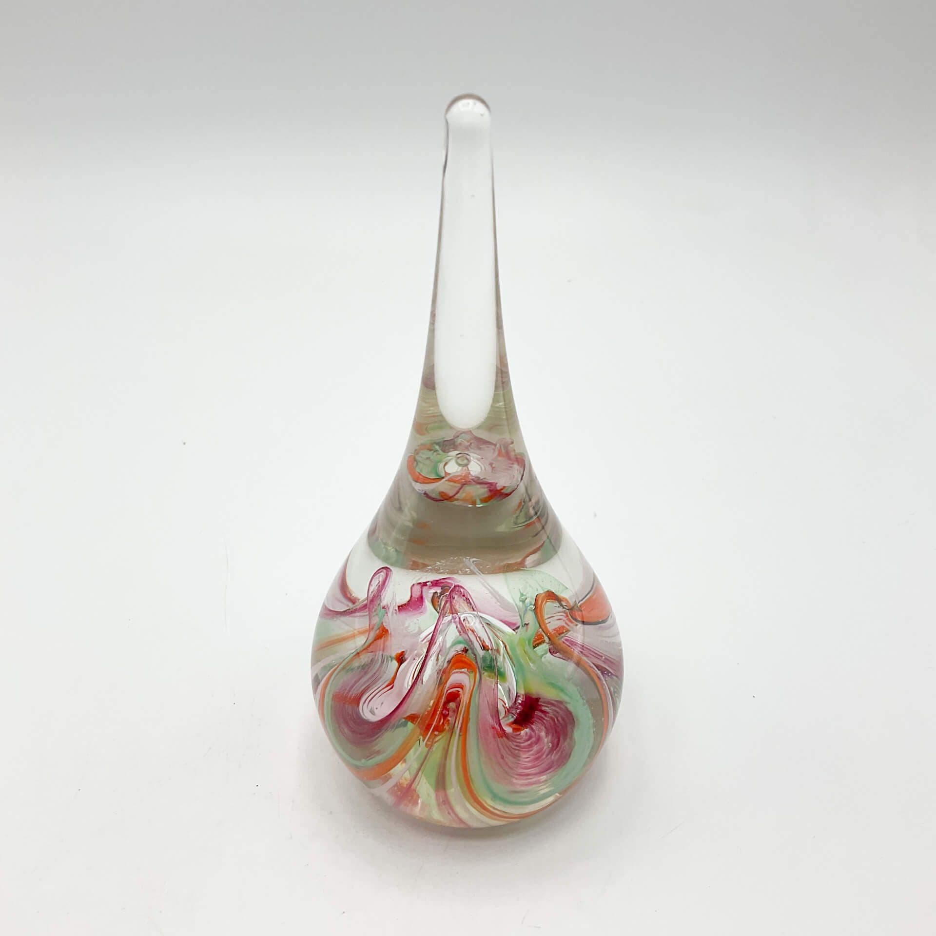 Selkirk glass paperweighrt with multicoloured swirls on a white background.
