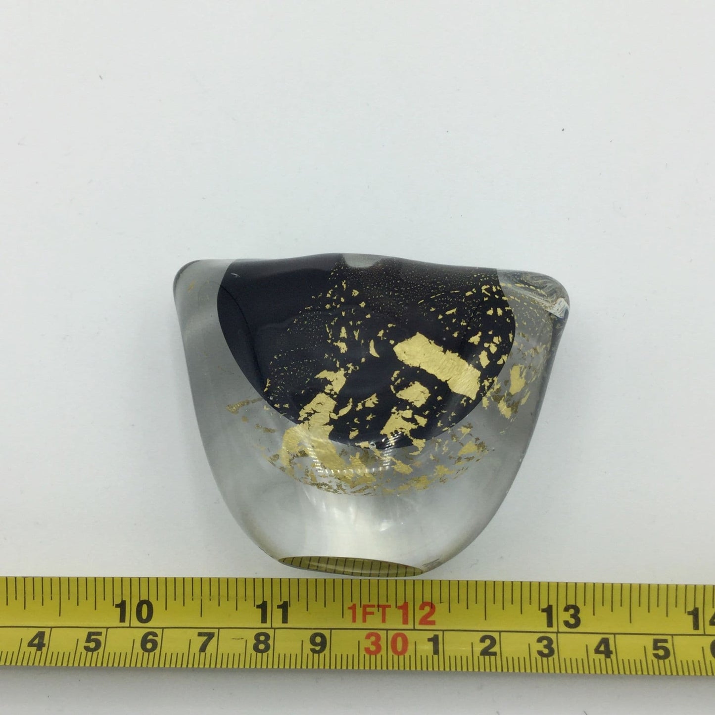 Small art glass vase next to a tape measure showing the size as approximately 9cm