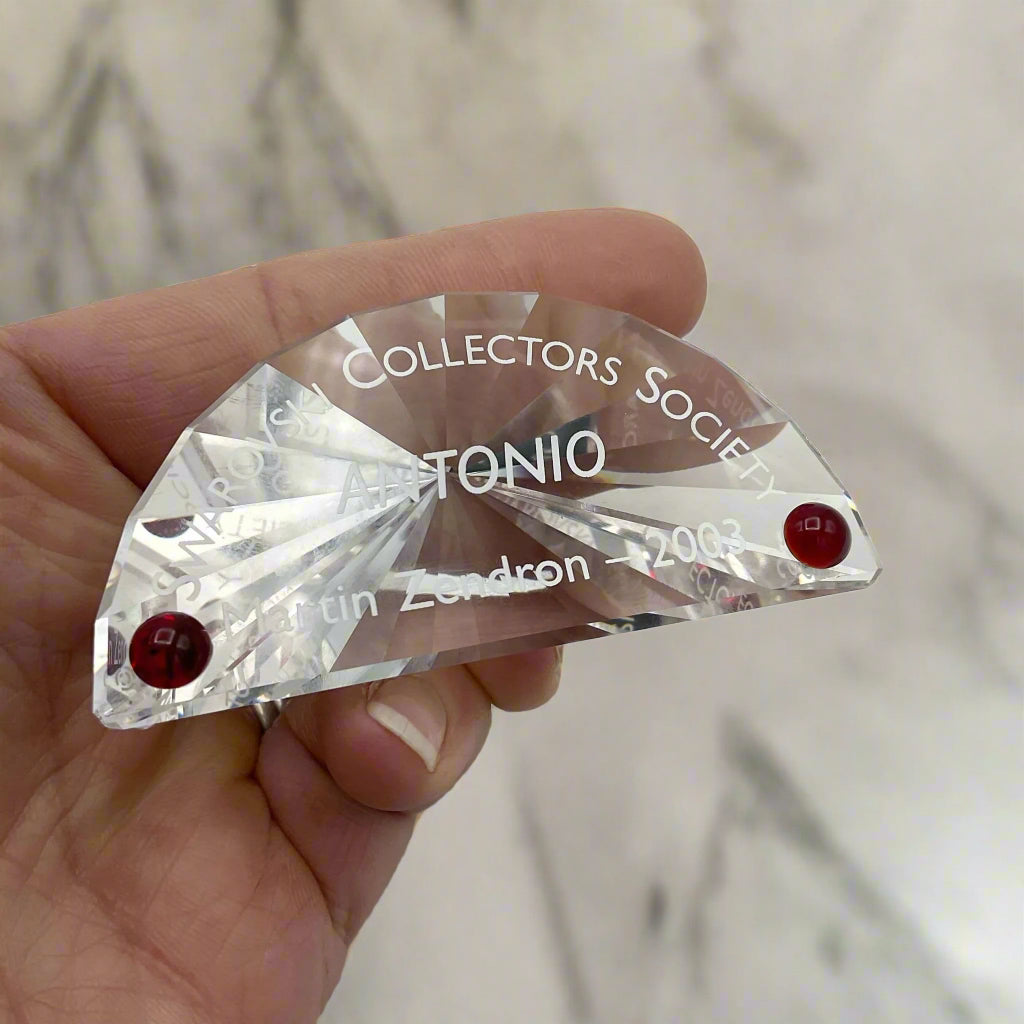 Swarovski  Crystal Antonio plaque held in a hand with a marble background