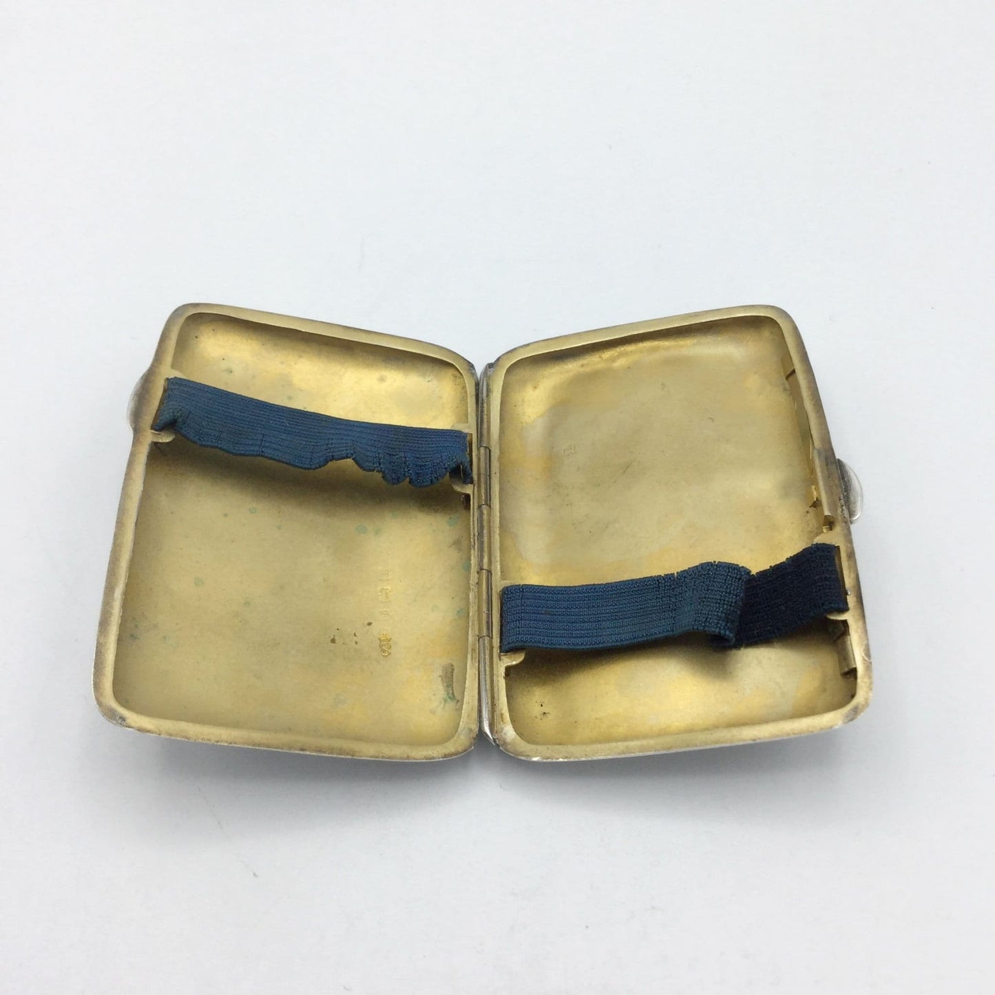 Beautiful gilded interior of a silver cigarette case with two straps