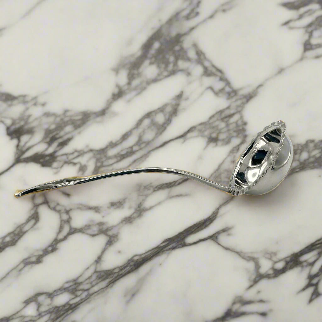 small ladle on a marble surface