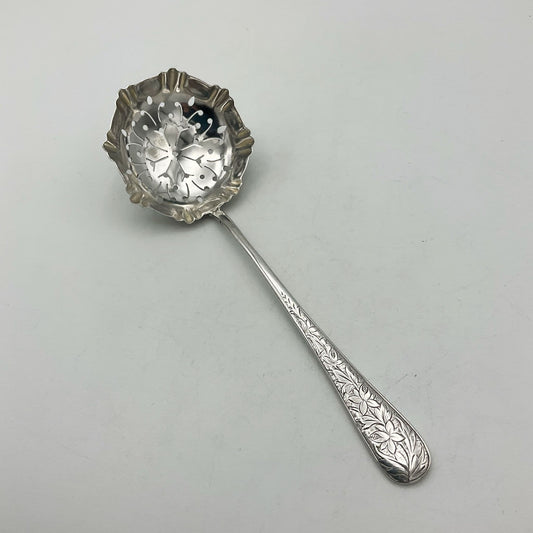 Antique Silver Sifter Spoon with flowers on the handle on white background