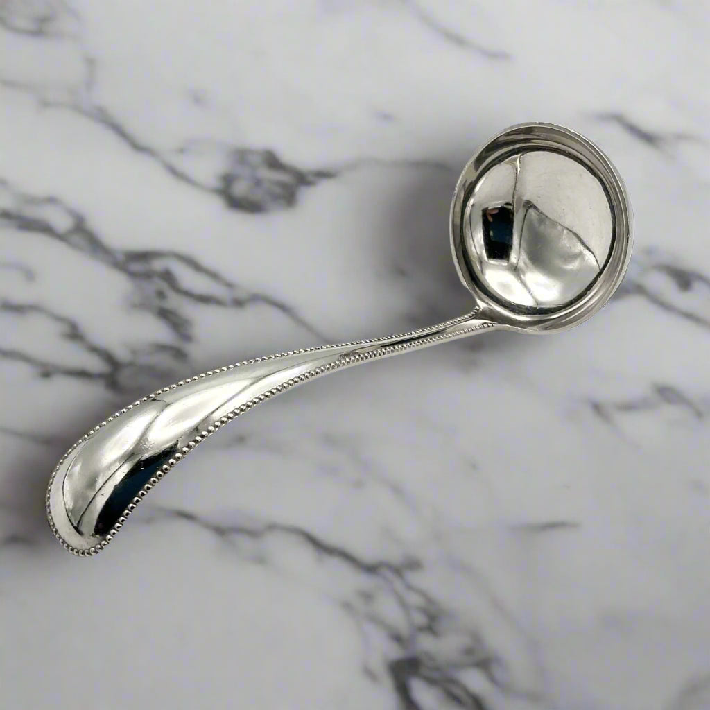 silver ladle on a marble surface