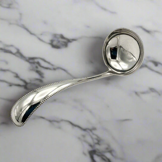 silver ladle on a marble surface