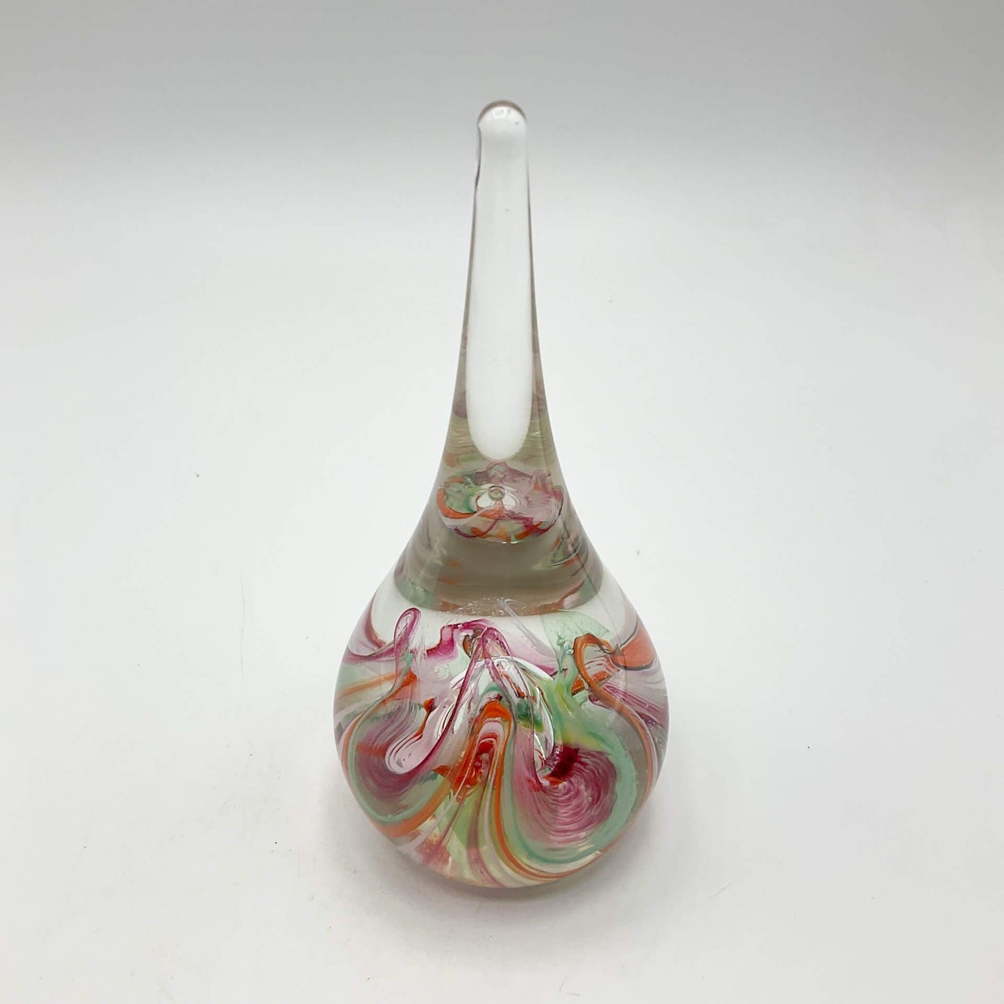Selkirk glass paperweighrt with multicoloured swirls on a white background.