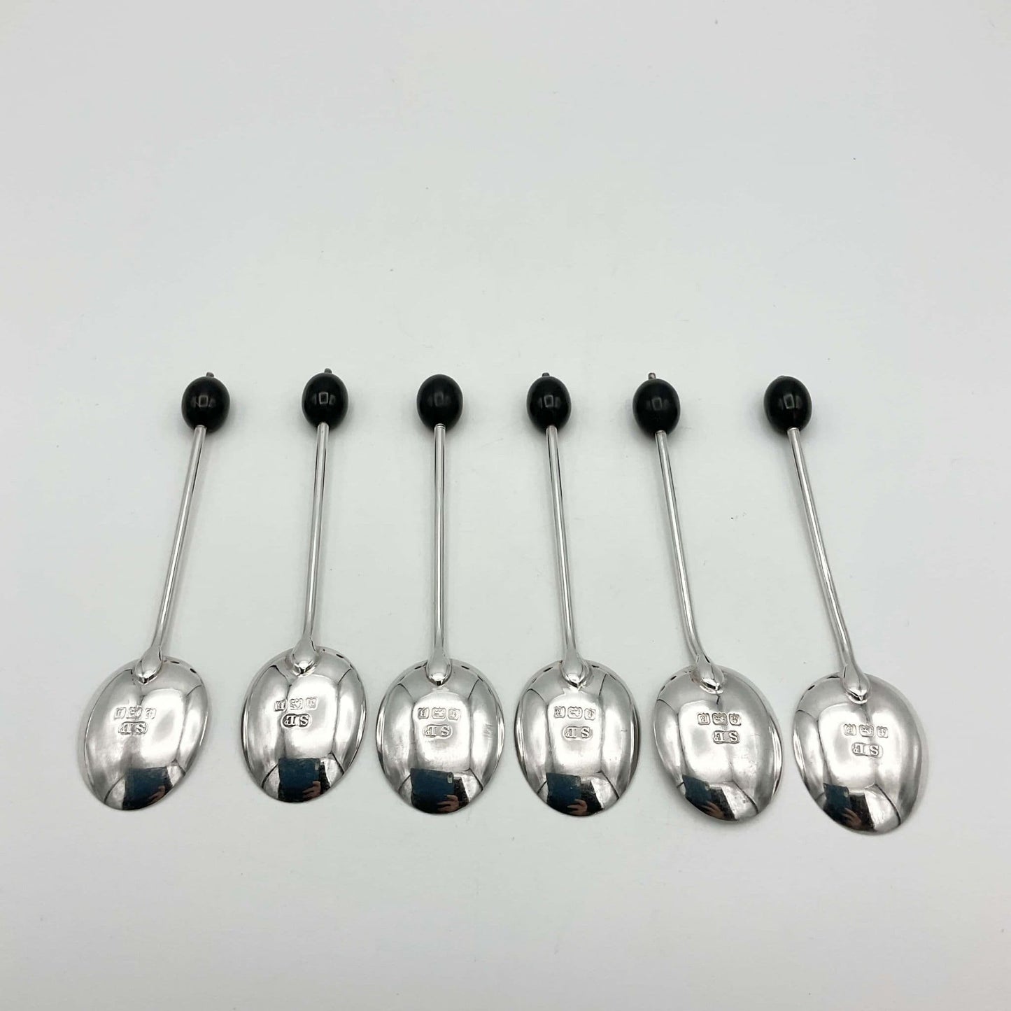 Six silver coffee spoons with Hallmarks on the base of the bowls and coffee bean finials