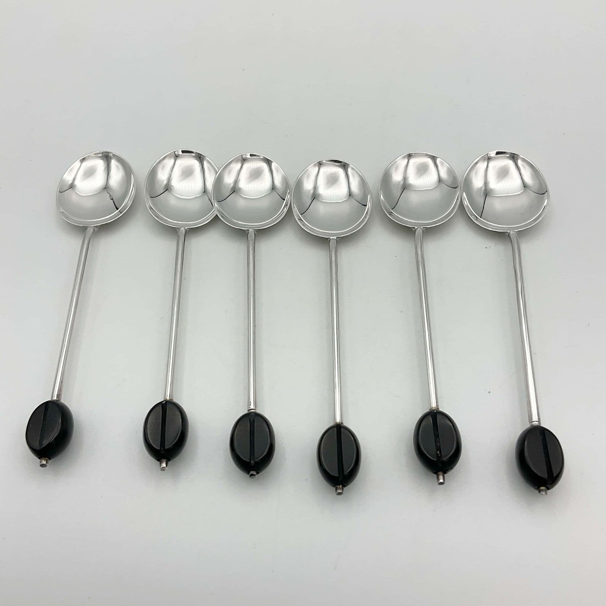 Six elegant silver coffee spoons with black coffee bean finials