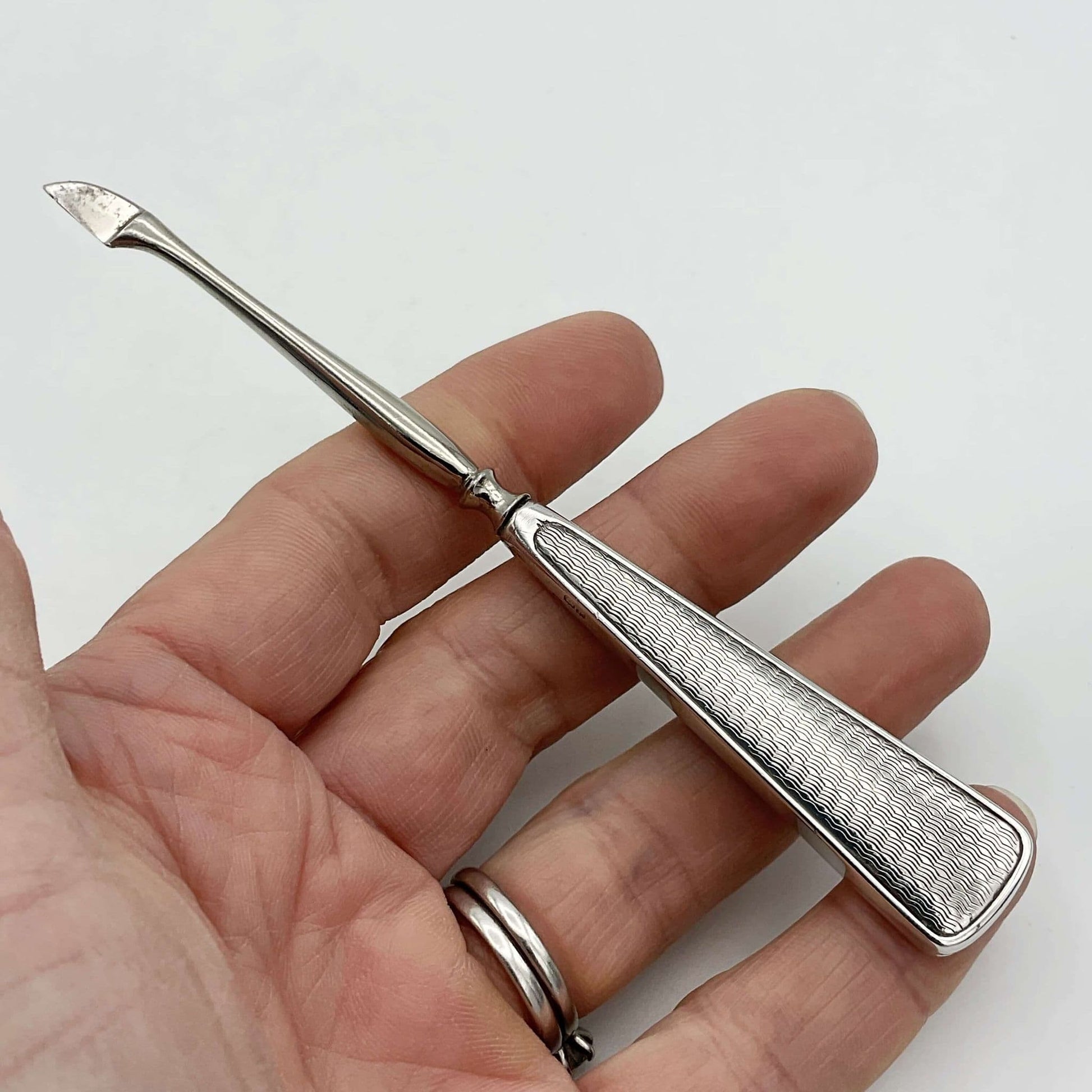 Vintage cuticle pusher held in a hand