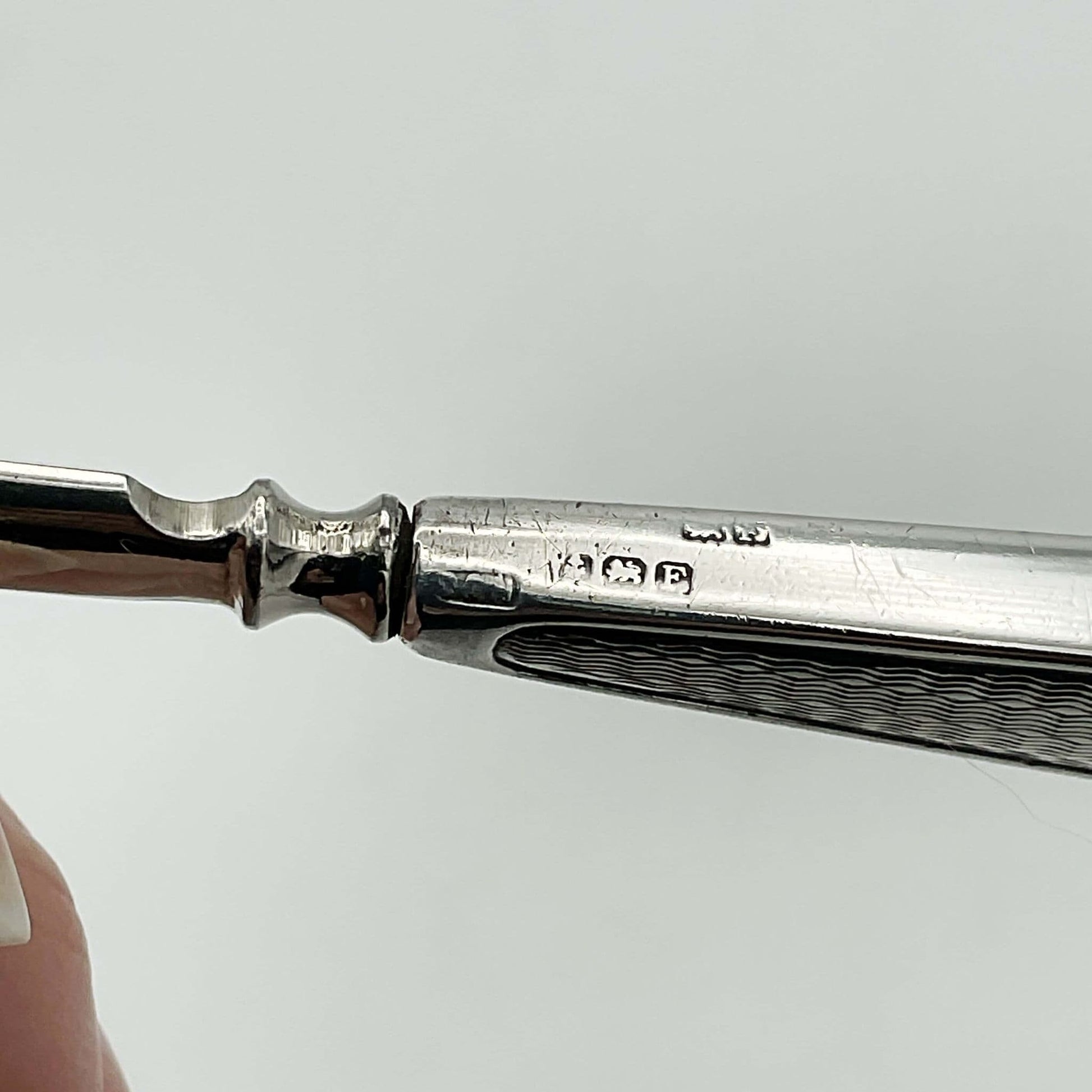 Hallmarks on the siilver handles of a manicure set.