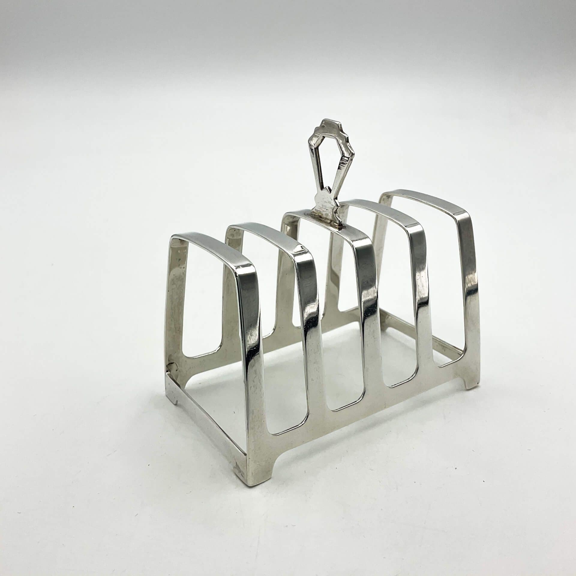 Art deco style silver toast rack on a white background.