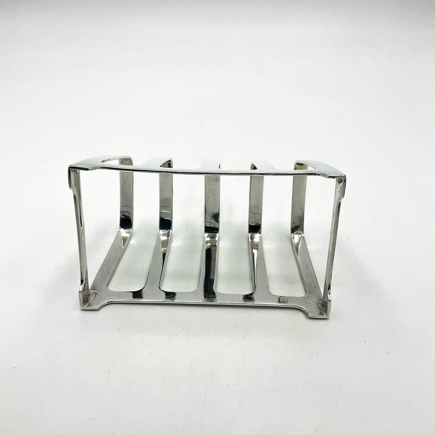 Base of Art deco style silver toast rack on a white background