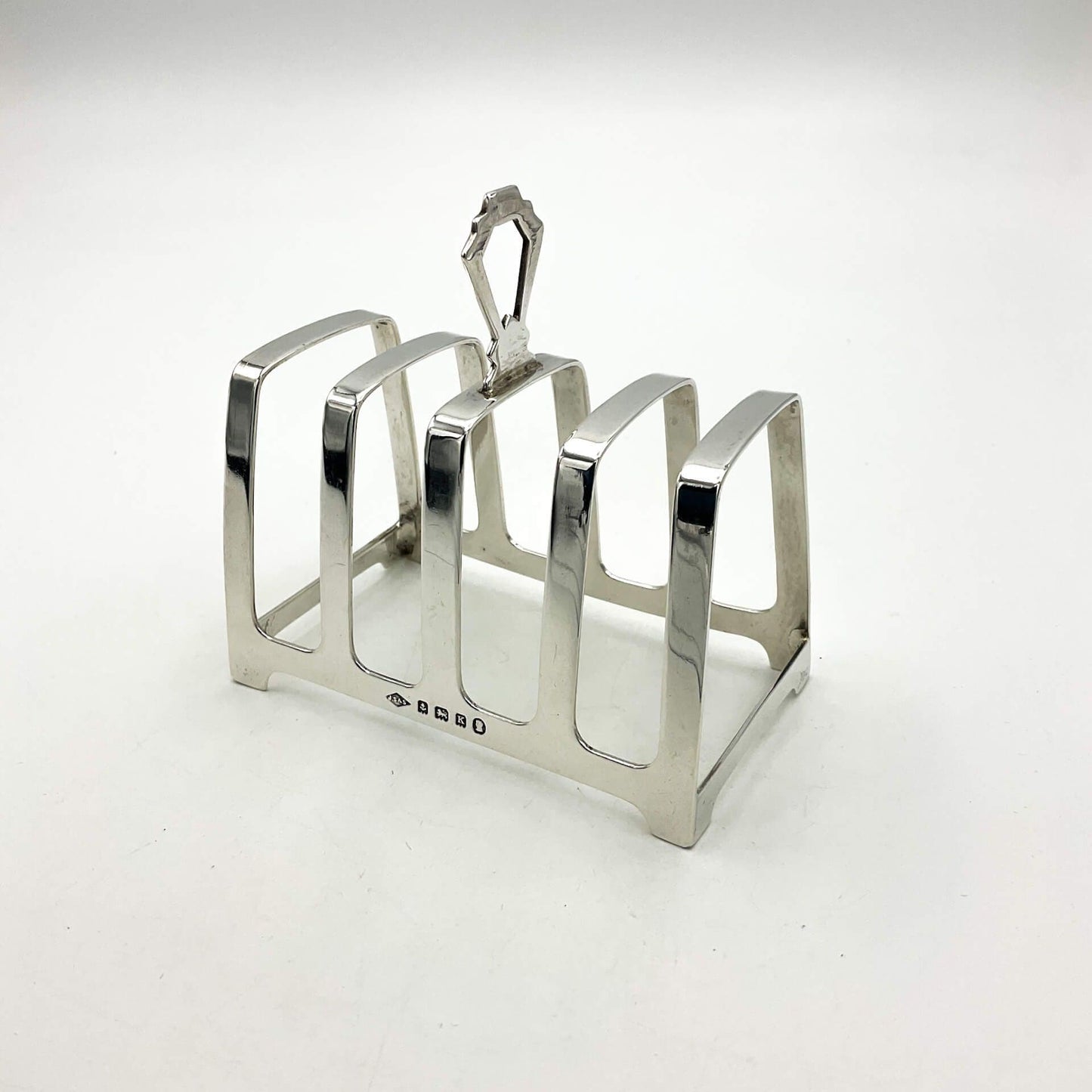 Art deco style silver toast rack on a white background