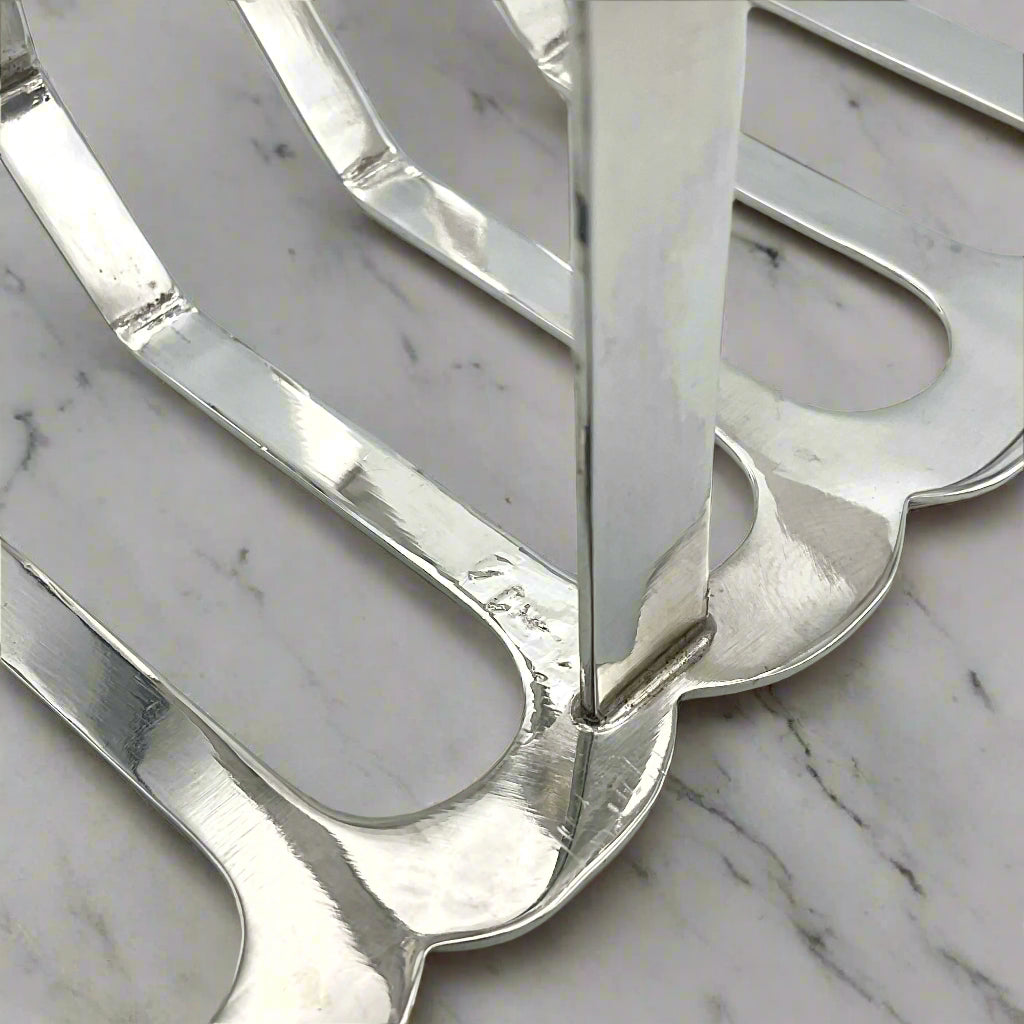 1935 Art Deco Sterling Silver Toast Rack  inside arm on a marble surface