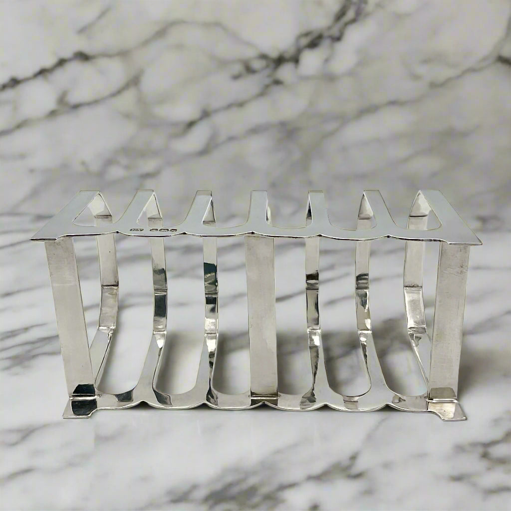 1935 Art Deco Sterling Silver Toast Rack on it's side on a marble surface