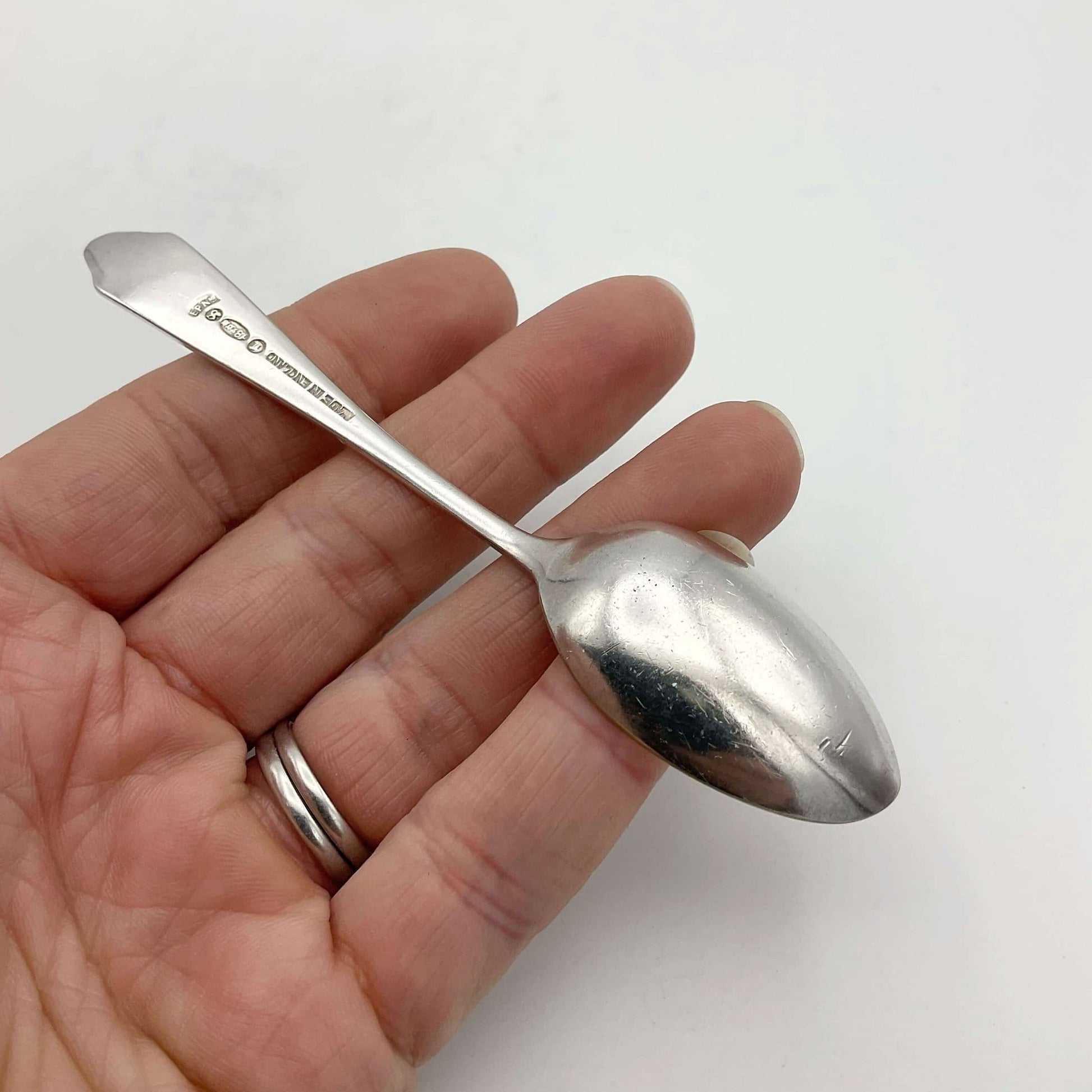 Back of coffee spoon held in a hand