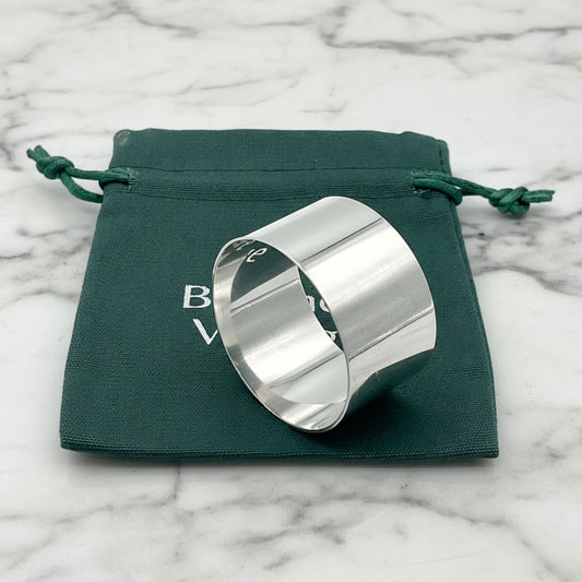 Shiny plain napkin ring sitting on a green Beeches Vintage cotton bag.