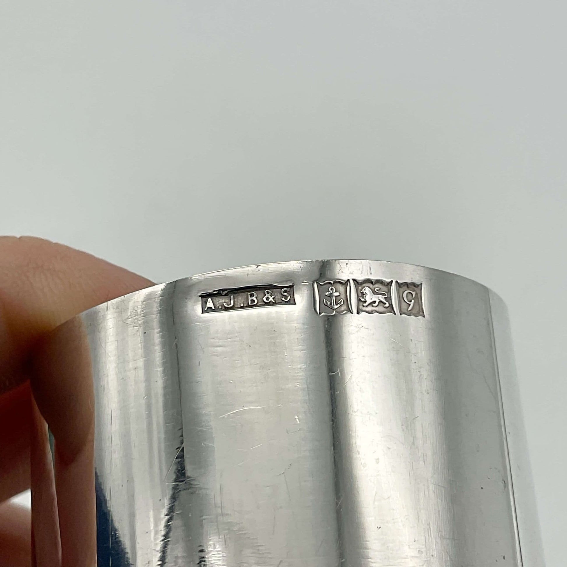 The hallmarks and makers mark on the side of the silver napkin ring