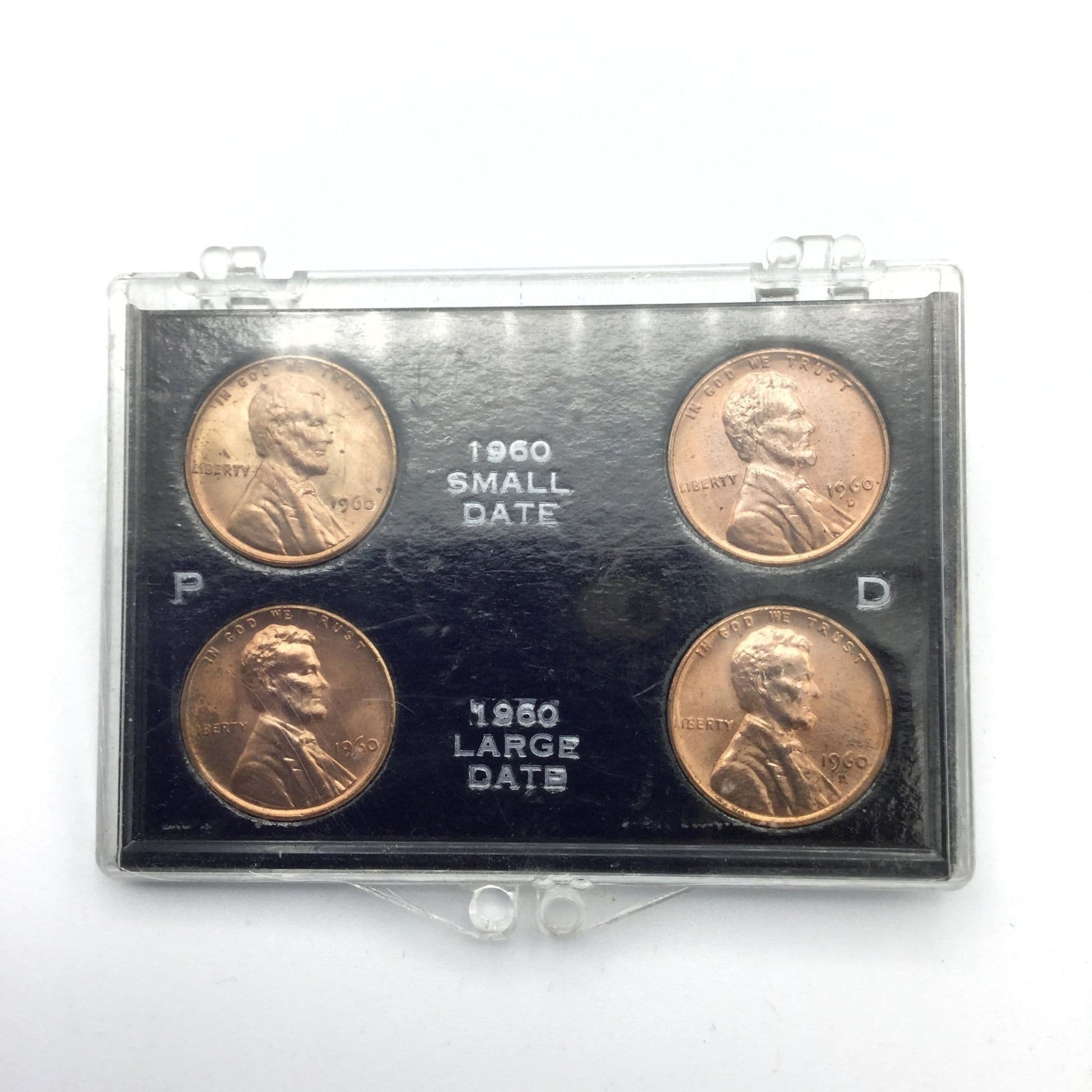 Four Lincoln Memorial Cents in a black holder and perspex case. It has P and D on the blakc holder and 1960 small date and 1960 large date on the black holder.