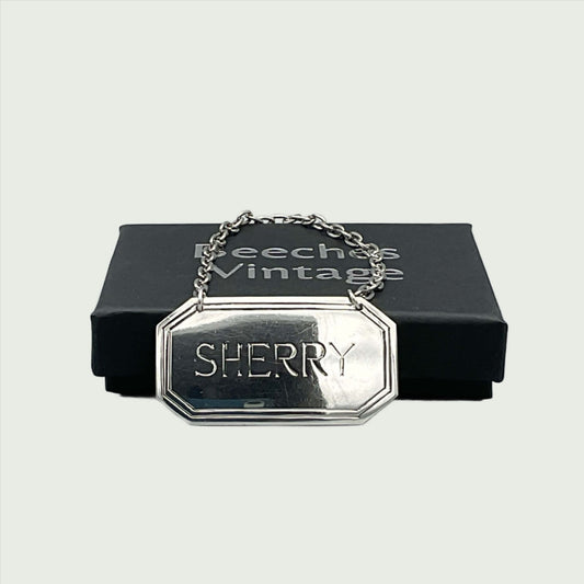 Silver Sherry decanter label in front of a black presentation box