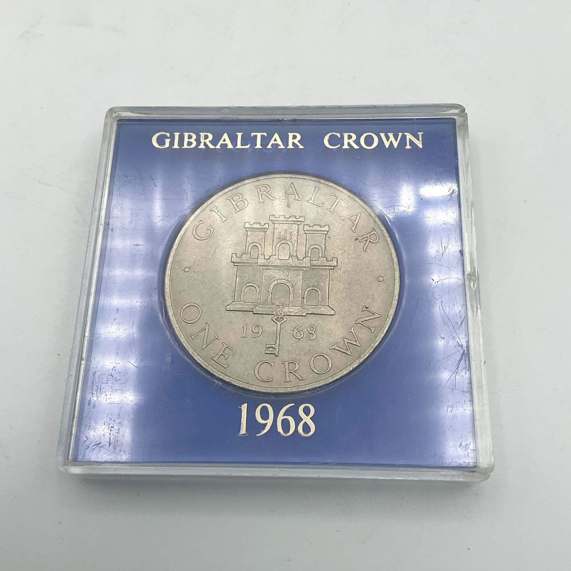 Silver Gibraltar Crown coin in a blue case
