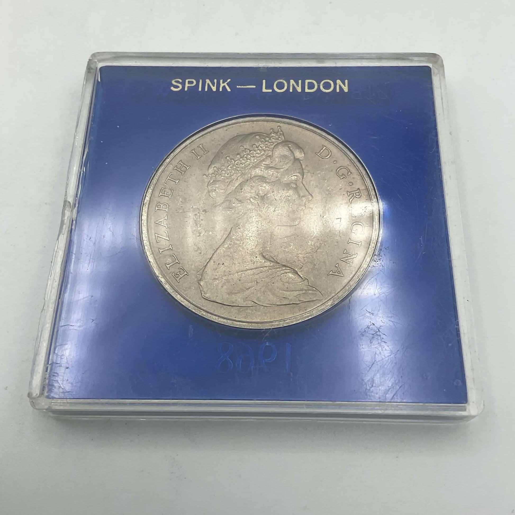Silver Gibraltar Crown coin in a blue case Reverse side