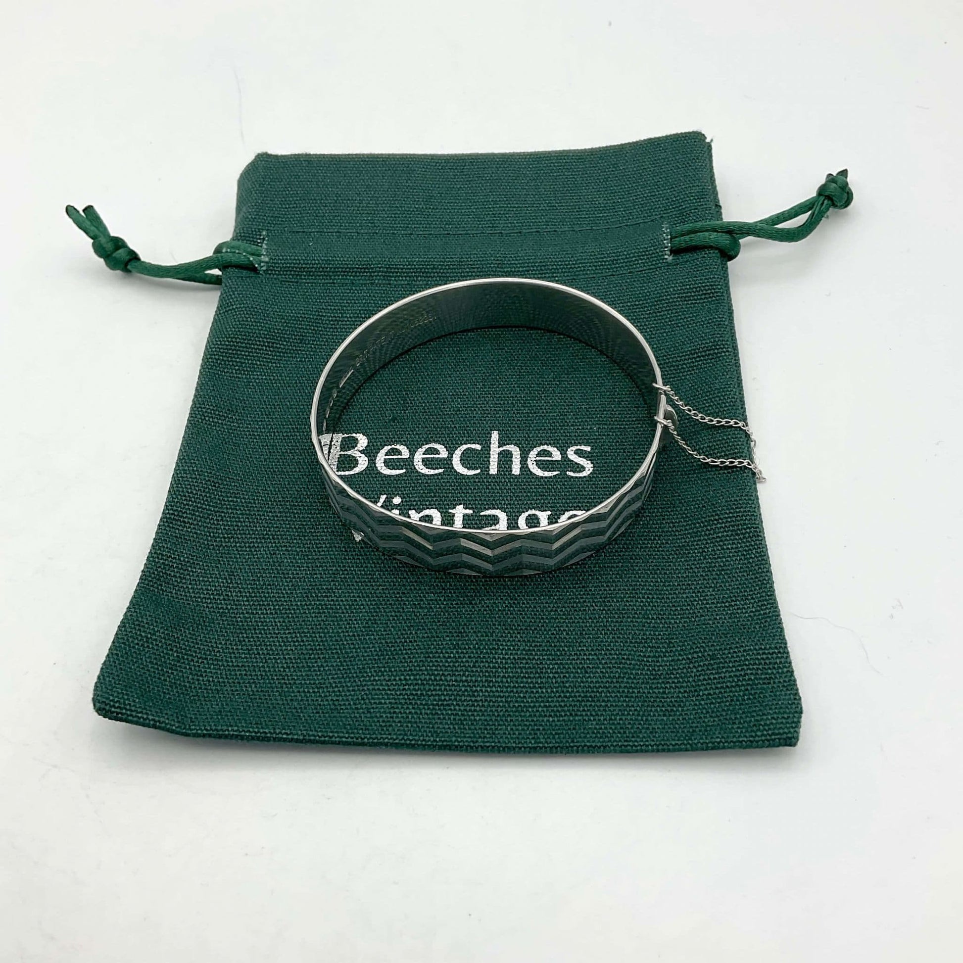 Bracelet with zig zag design on green gift bag