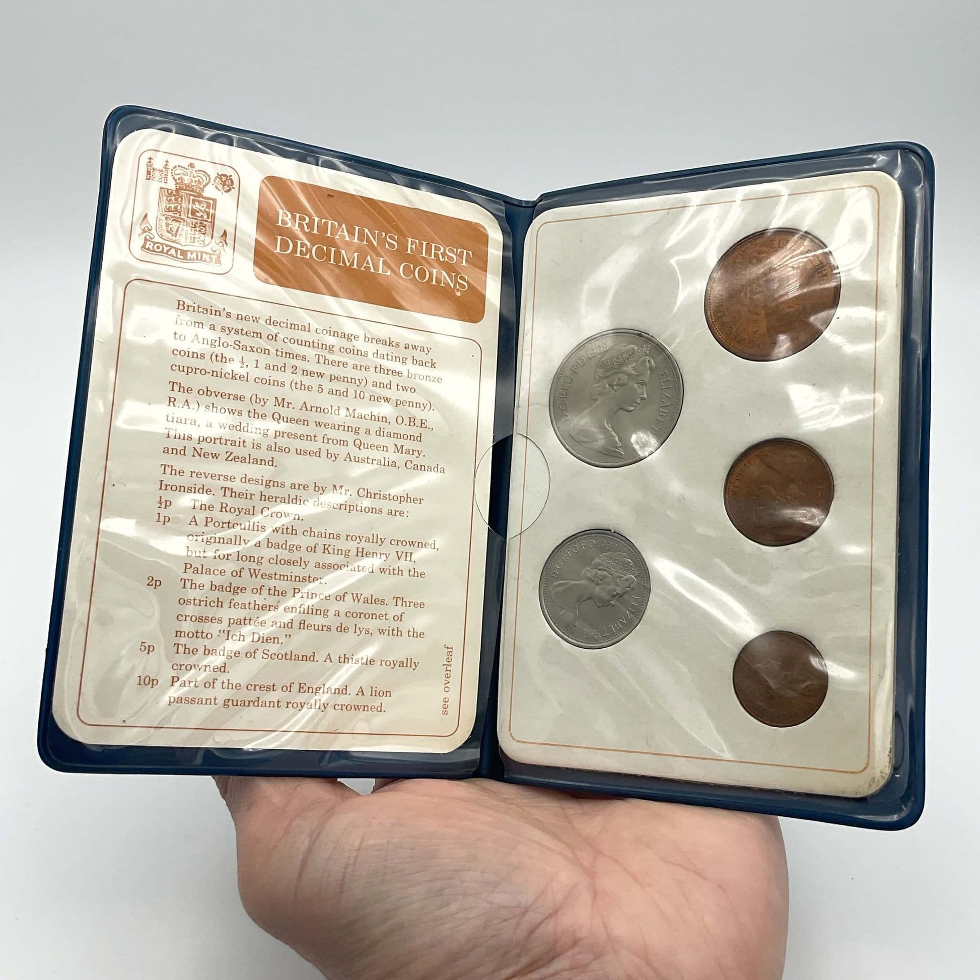 The open view of the coins in Britain's First Decimal Coins Set showing the coins and description