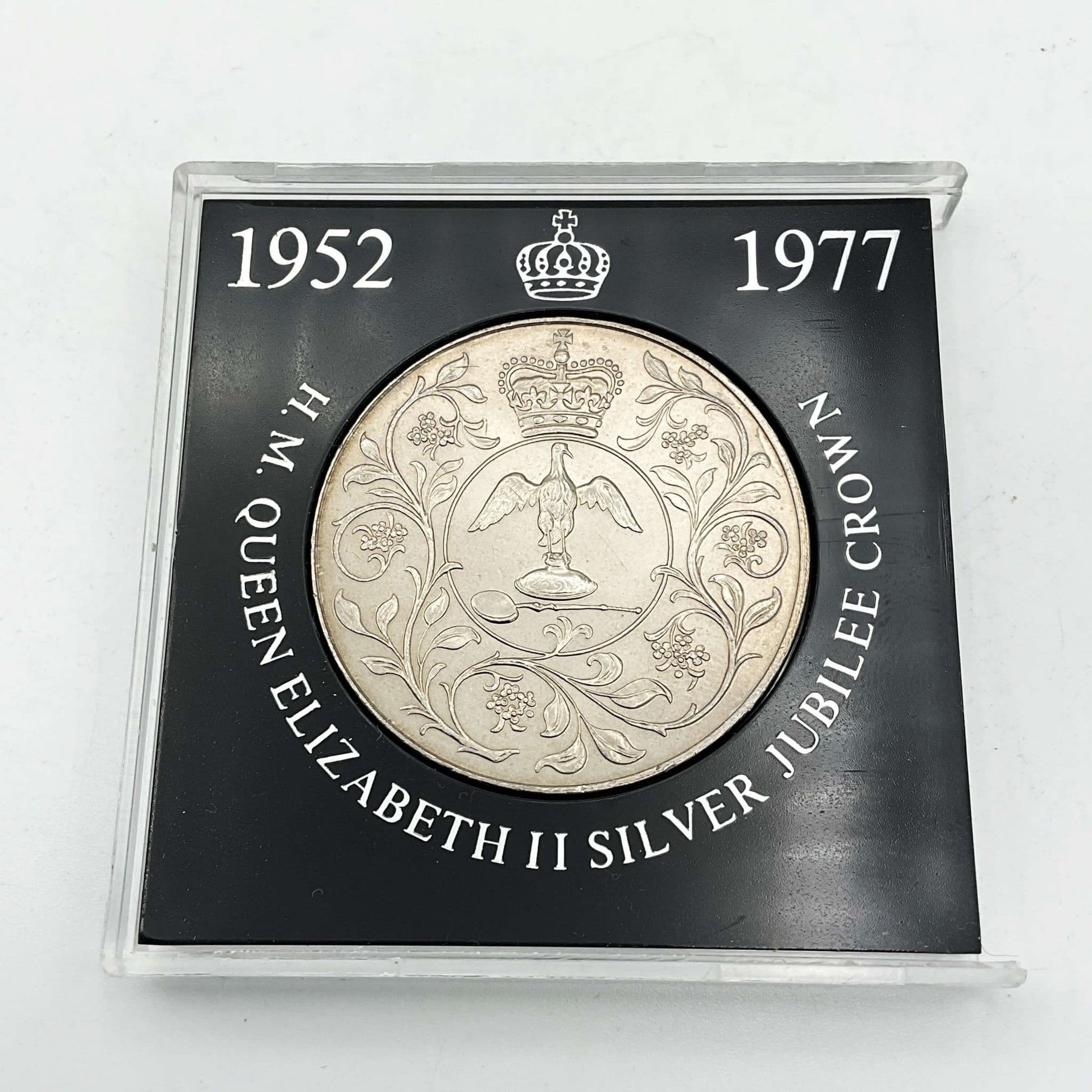 silver crown coin in a black case with HM Queen Elizabeth II Jubliee Crown with the perspex cover removed